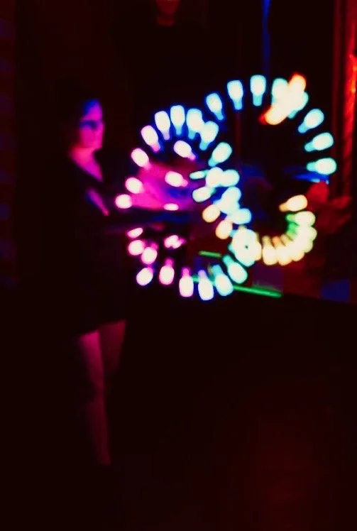 Person performing with LED Baton lights creating a circular light pattern in a dark room. Hawkes Cay Resort and Villas, Duck Key, Florida, Florida Keys.