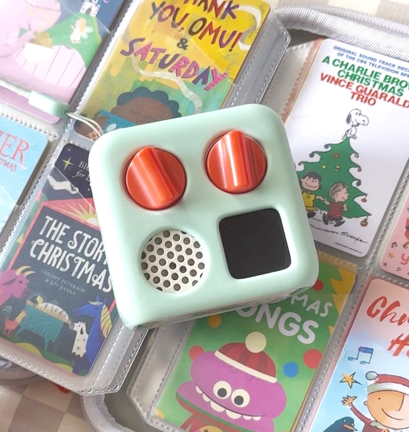 A Yoto Player on top of a collection of yoto cards.