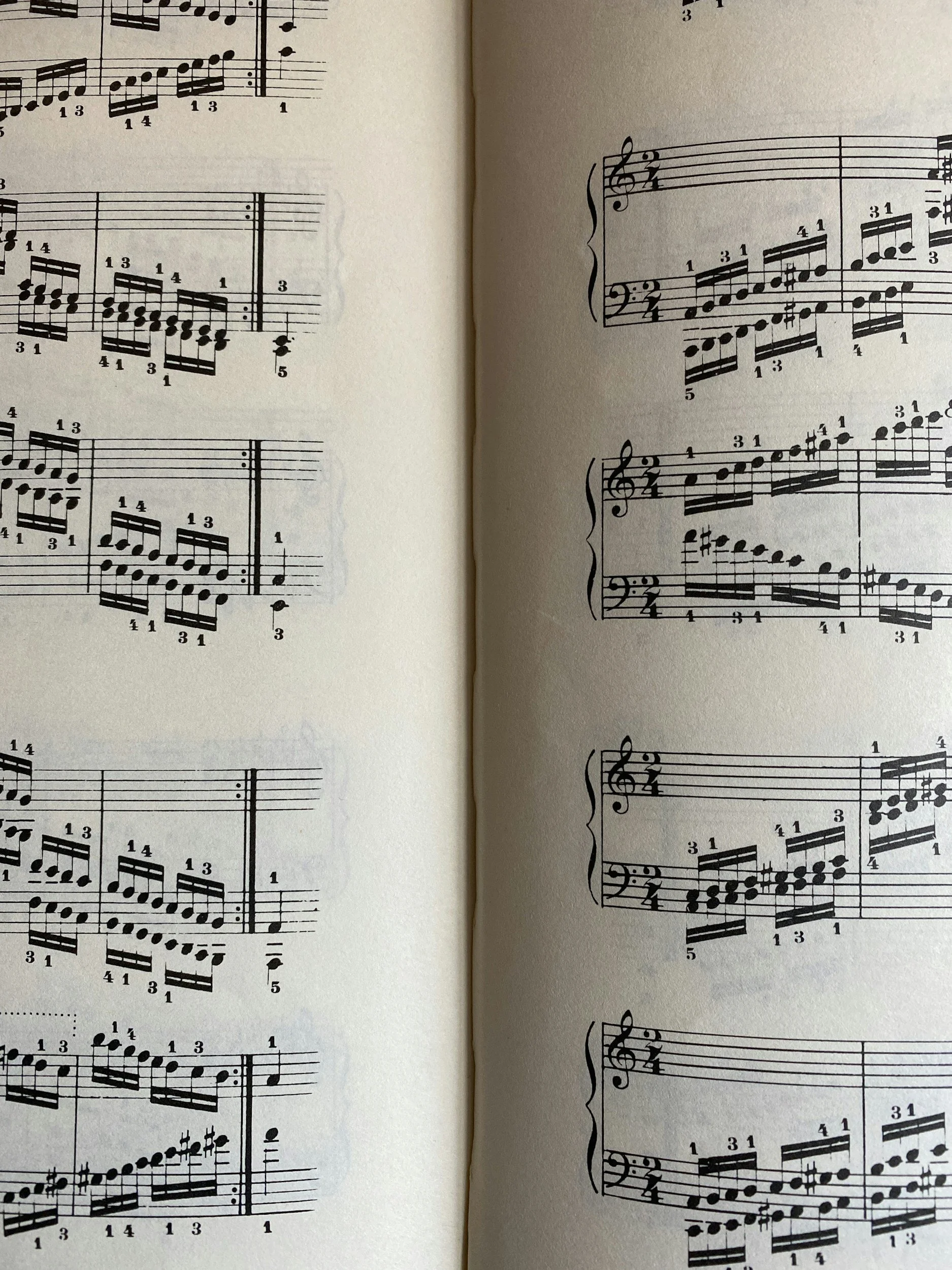Open music scorebook with printed sheet music containing musical notes, fingerings, and annotations.