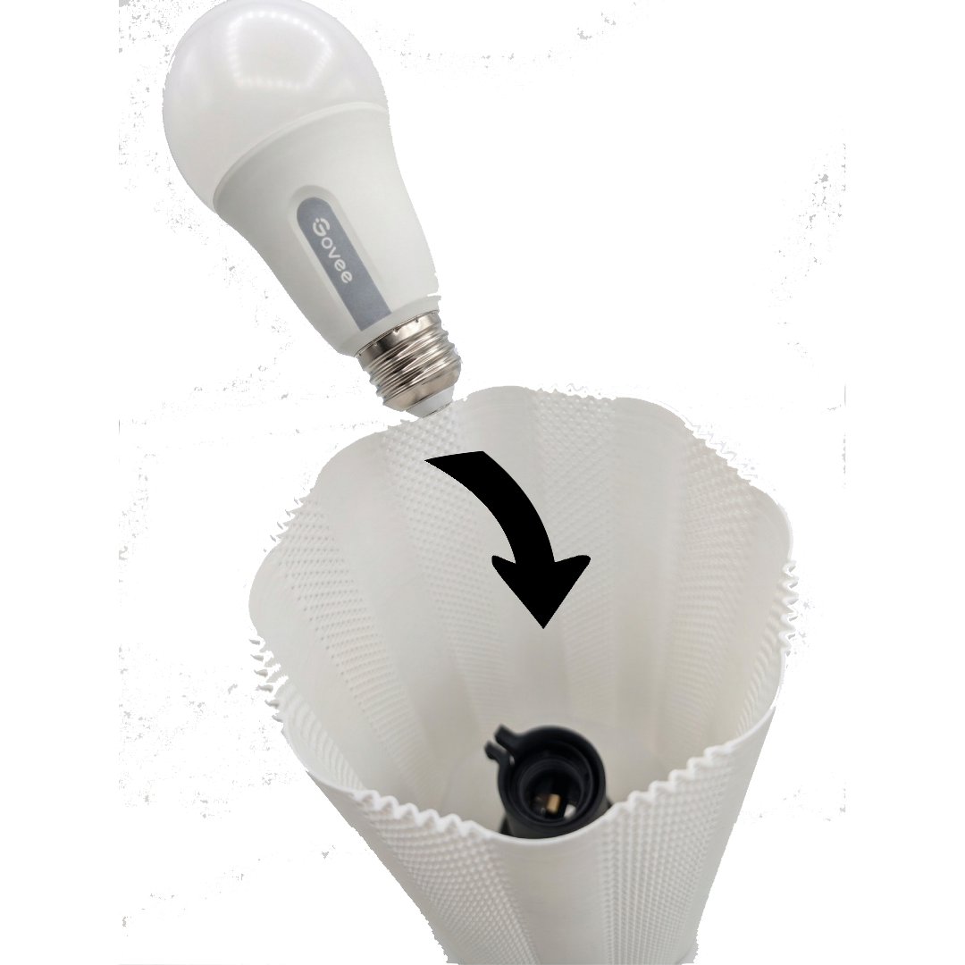 An LED light bulb being inserted into a white, textured, conical lamp shade with a black socket inside.