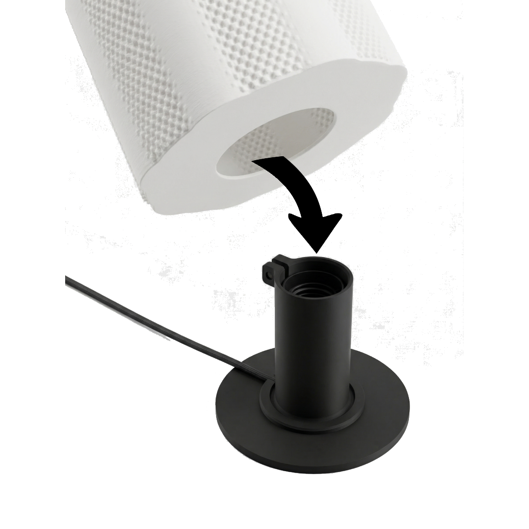 A black mounting bracket connected to a black cable, with a large white cylindrical object with a textured surface above it.