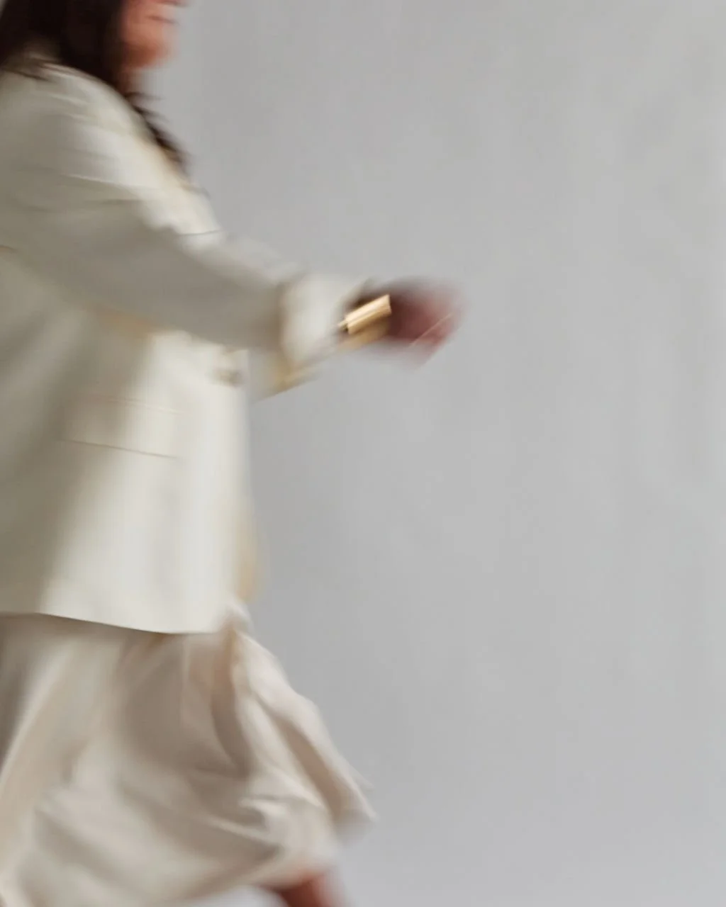 Advisor Tanya Jacobson in a cream blazer depicting movement as she scales founder-led businesses and removes dependency