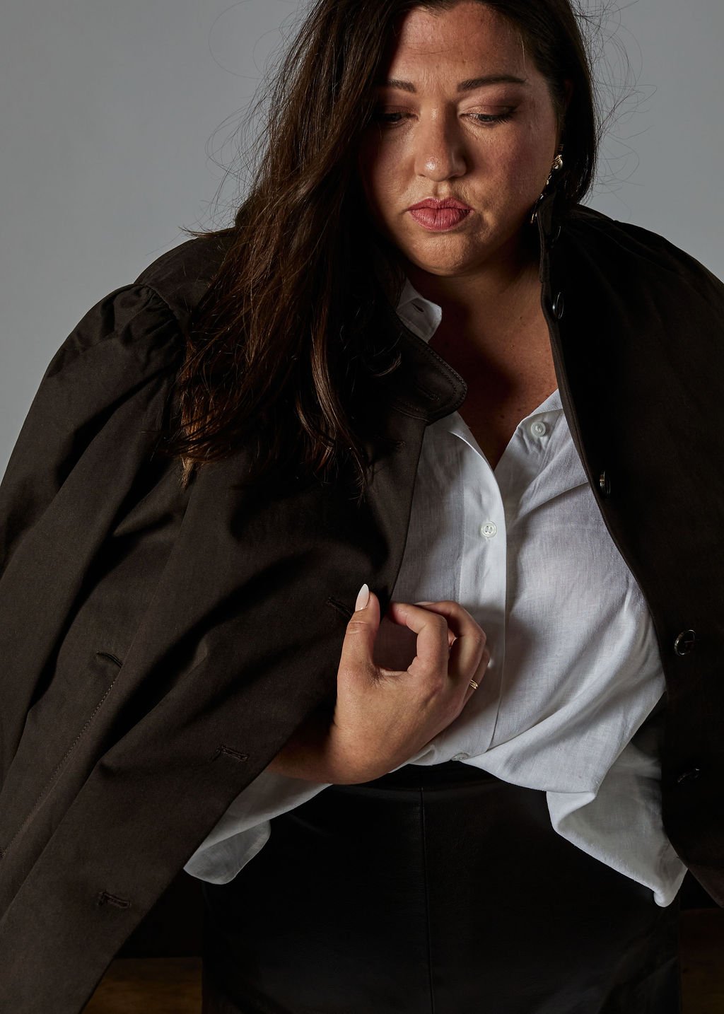 Tanya Jacobson, Capacity advisor that removes founder dependency and expands capacity for scaling founders, wearing a black blazer over a white shirt, with her hand adjusting the blazer.