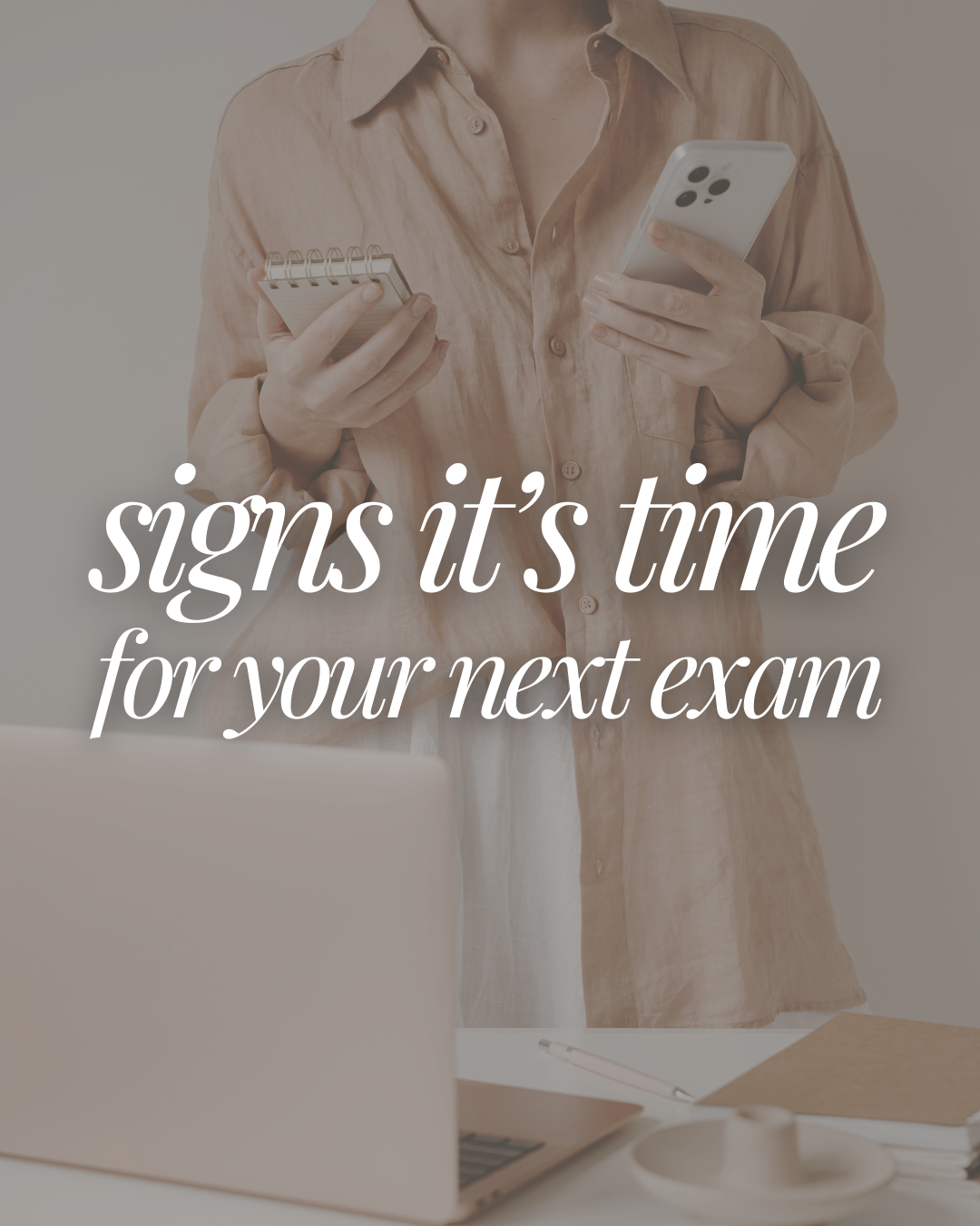 Person holding a smartphone and a notepad, standing in front of a table with a laptop and a cup, with overlaid text that reads 'signs it's time for your next exam'.