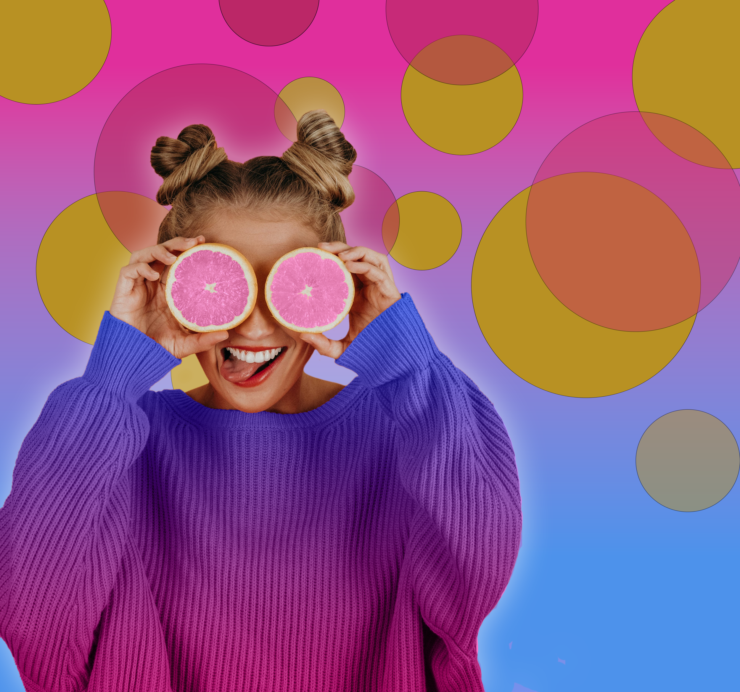 A young woman smiling and sticking out her tongue, holding two slices of pink grapefruit in front of her eyes, with a colorful, abstract background of pink, yellow, and purple circles.
