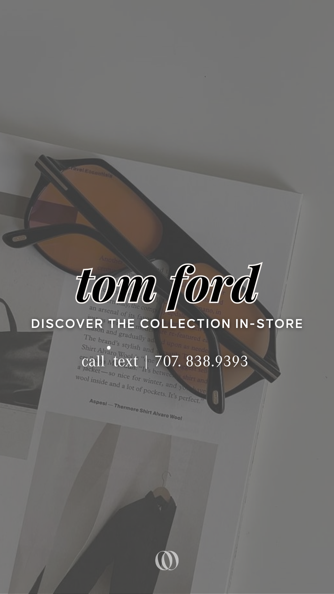 Pair of sunglasses with orange-tinted lenses resting on a white surface with a paper underneath, featuring text and a photograph of a clothing item.