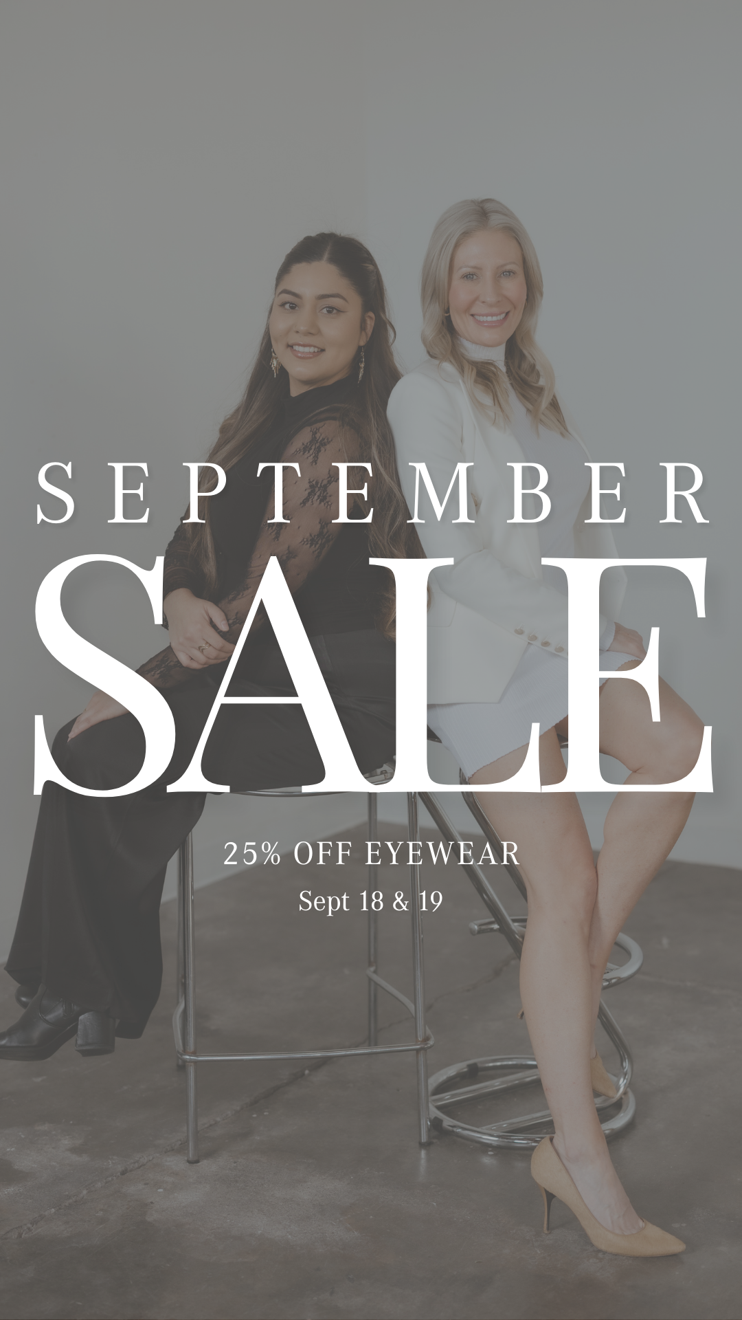 Two women sitting on bar stools with sales advertisement text overlay. The woman on the left has long dark hair, wears a black lace top, and black pants. The woman on the right has blonde hair, wears a white blazer and skirt. The background is plain 