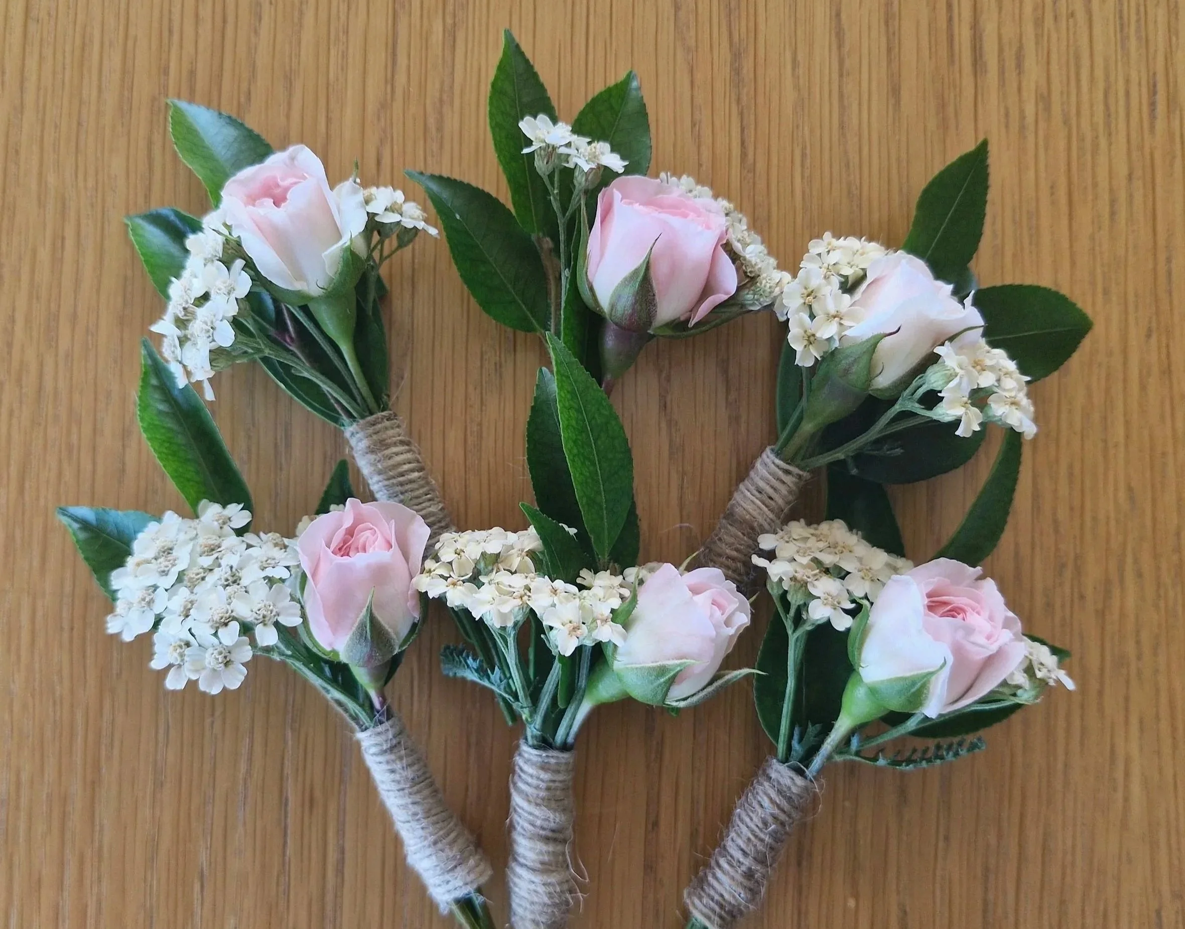 Wedding buttonholes for groom, groomsmen and mother of the bride, pink roses, wrapped buttonholes.