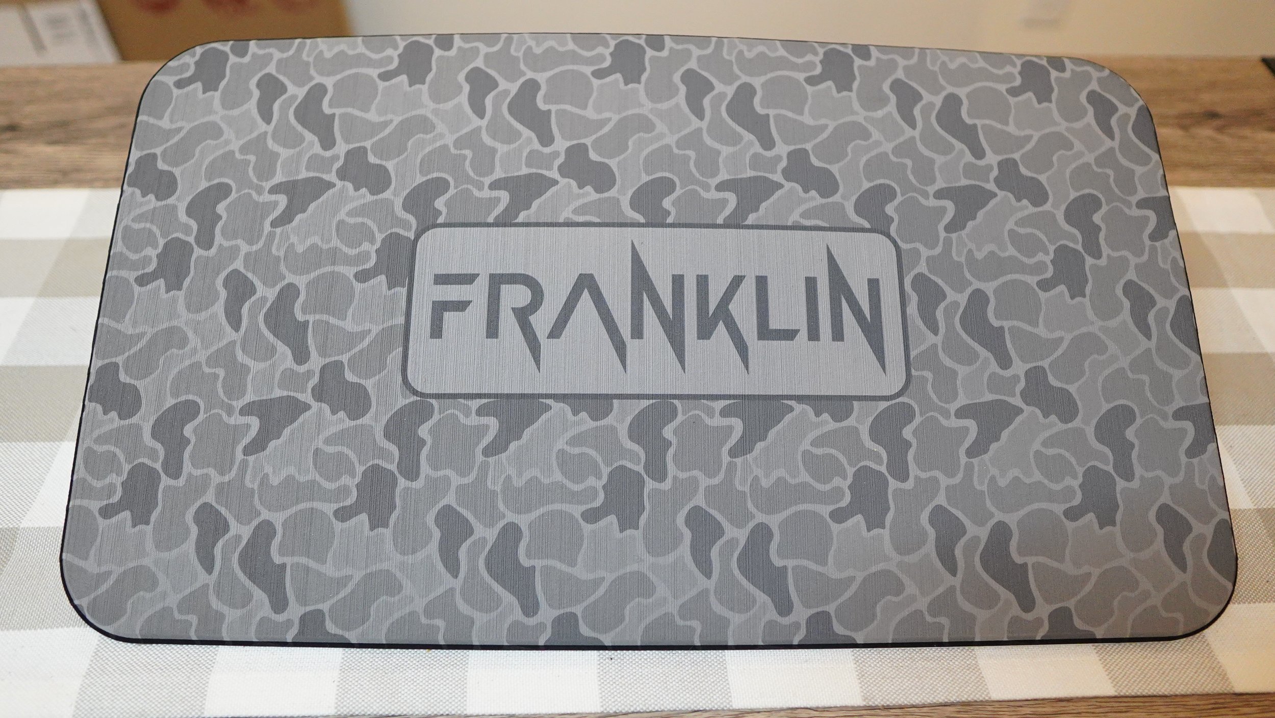 A rectangular metal box with a gray camouflage pattern and the word 'FRANKLIN' inscribed on it.
