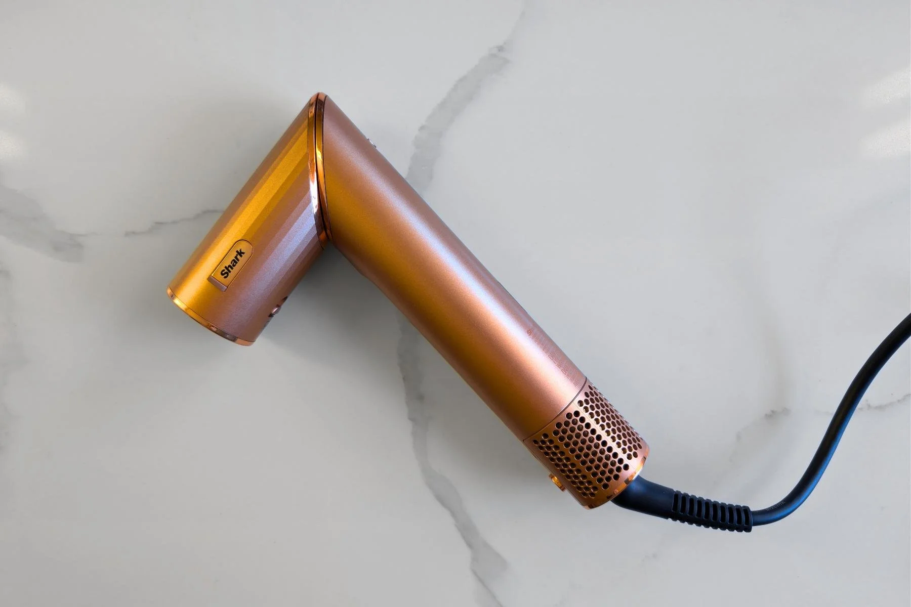 Shark Flexstyle hair dryer on marble surface used for fluff drying a Pomeranian coat