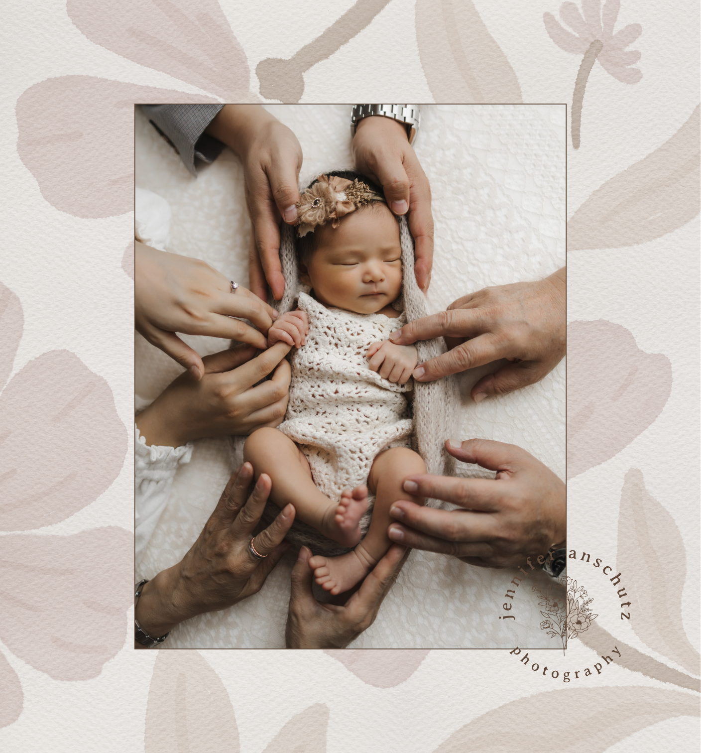 A newborn baby wrapped in a white crocheted blanket, sleeping peacefully with multiple hands gently touching and supporting the baby's body.