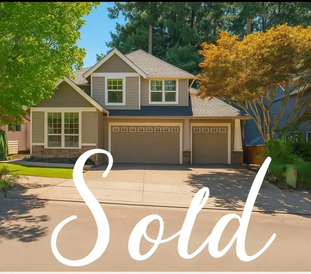 A two-story house with beige siding and a three-car garage, surrounded by green trees and a lawn, with the word 'Sold' written in white script across the front.