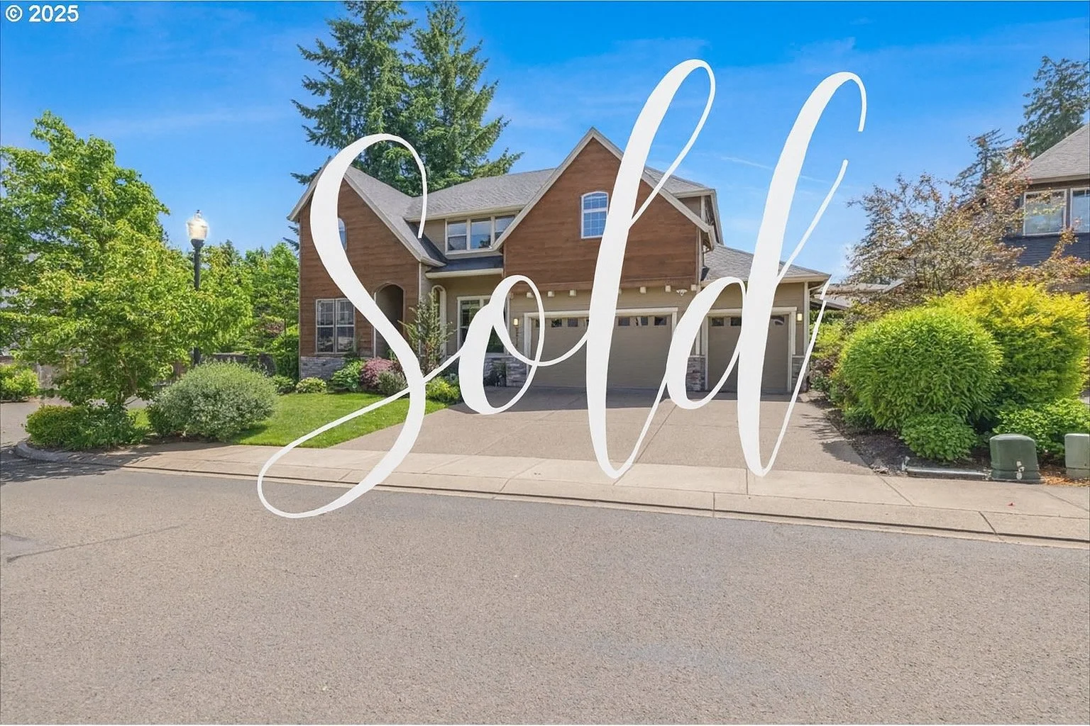 A house with a front yard, trees, and a driveway, with the word "Sold" in white cursive text across the image.
