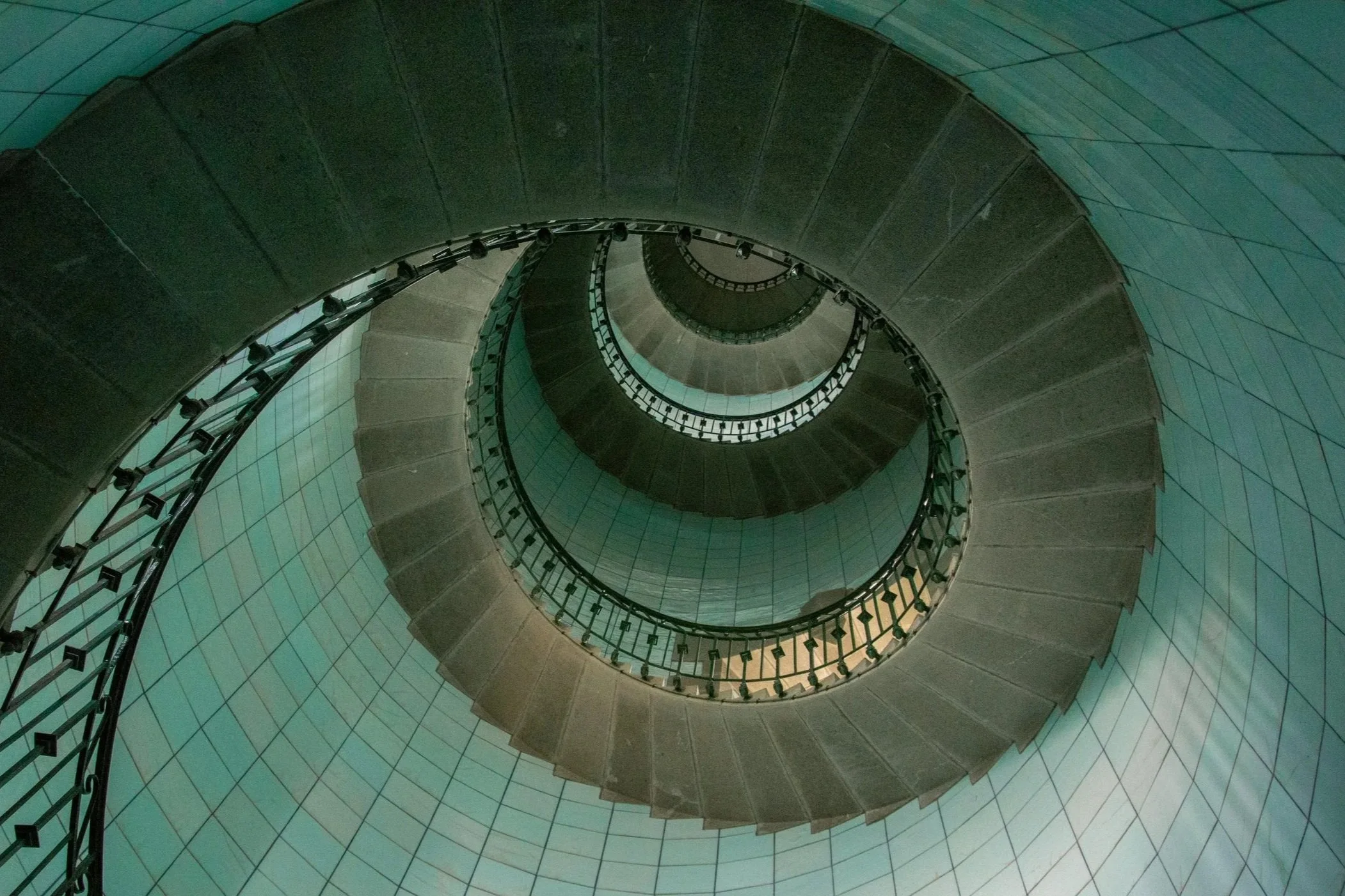 Spiral staircase viewed from above, looking down.