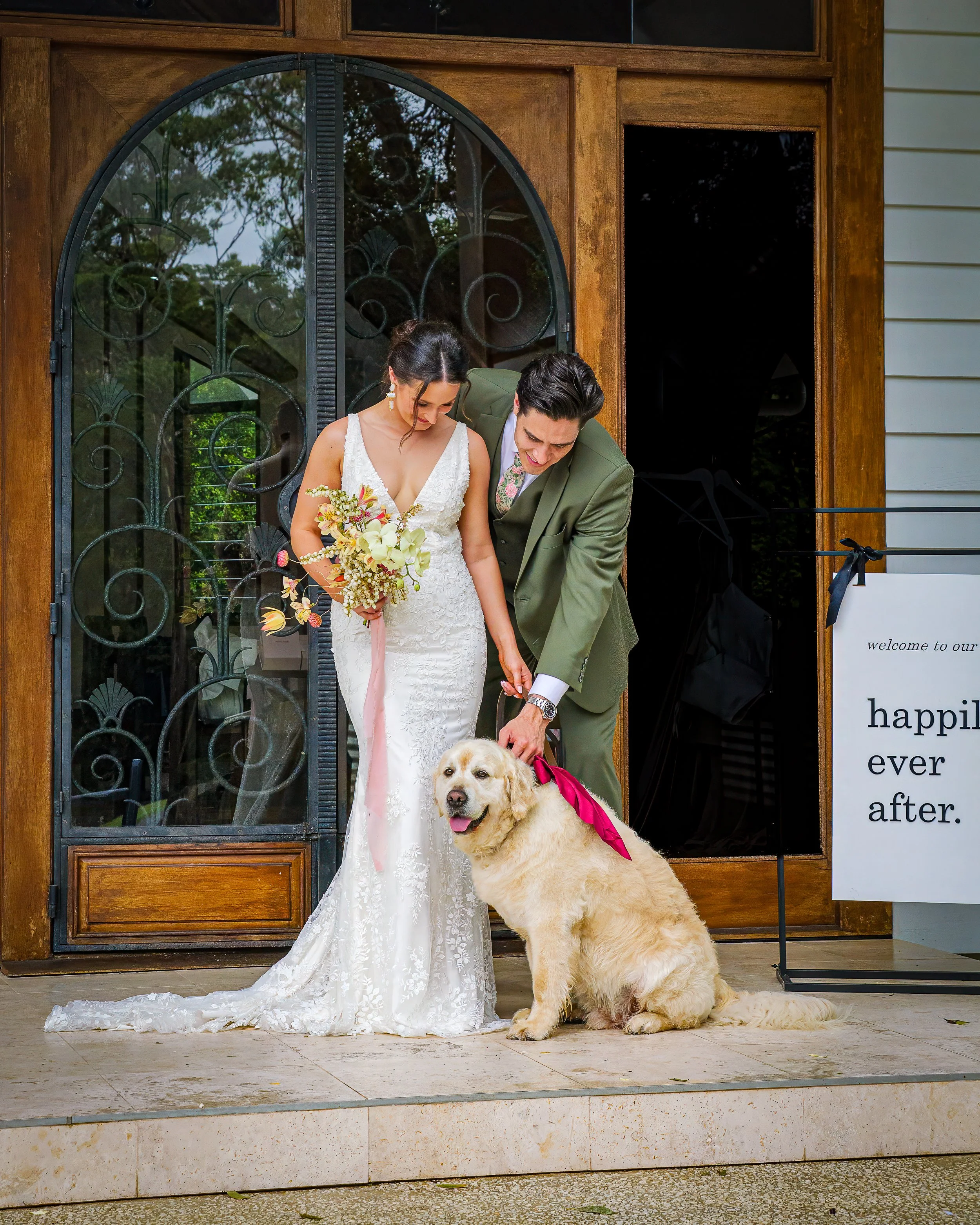 Golden Retriever with wedding couple after ceremony