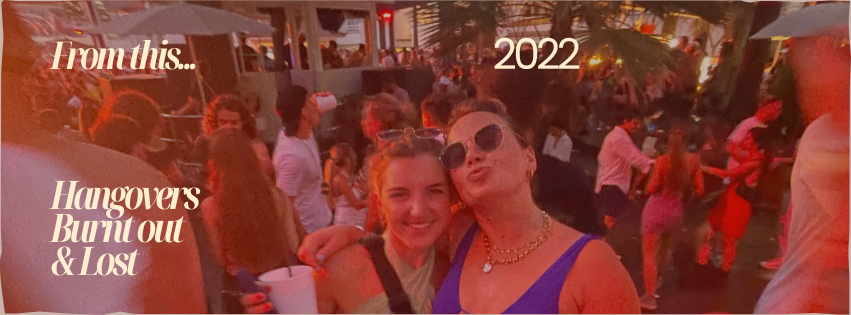 A group of people at an outdoor party or event in 2022, with two women in the foreground smiling and posing for the camera, amidst a crowded lively scene.