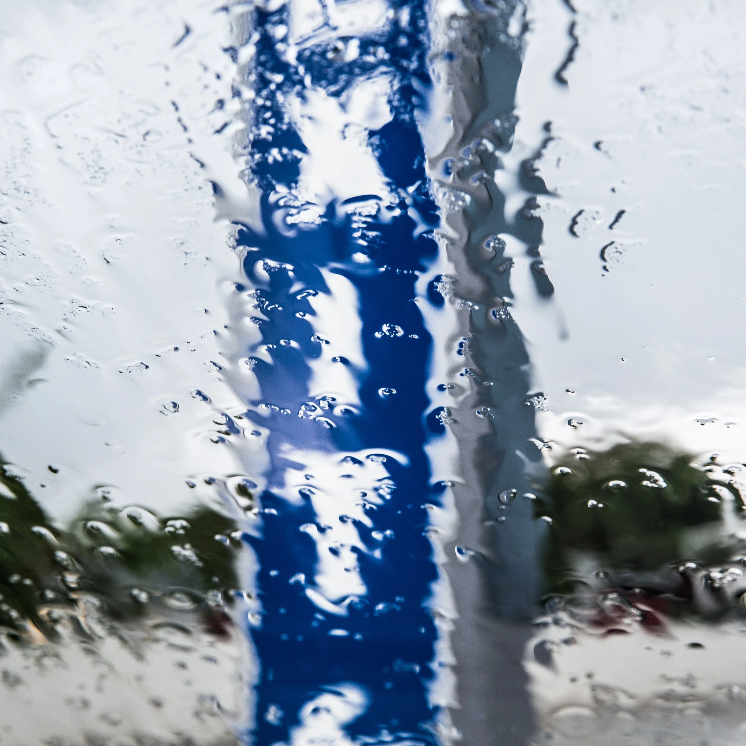 in Mauritius, into the car photo, Close-up view of a water surface with water droplets and ripples.