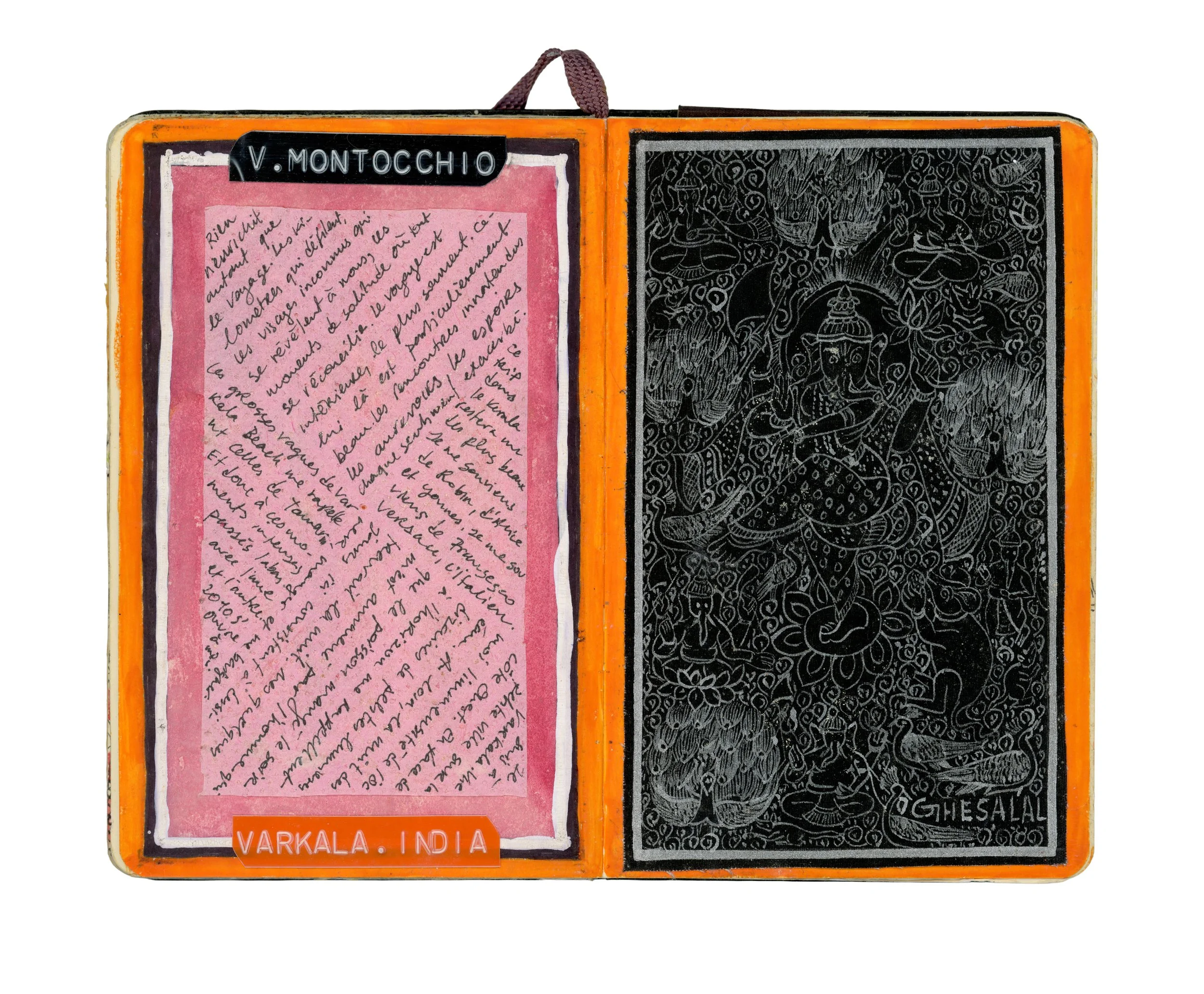 Open travel journal with handwritten notes on the left page and a detailed black and white line drawing of a Hindu deity on the right page. The journal has an orange border and a purple fabric loop at the top. There is a label at the bottom reading "
