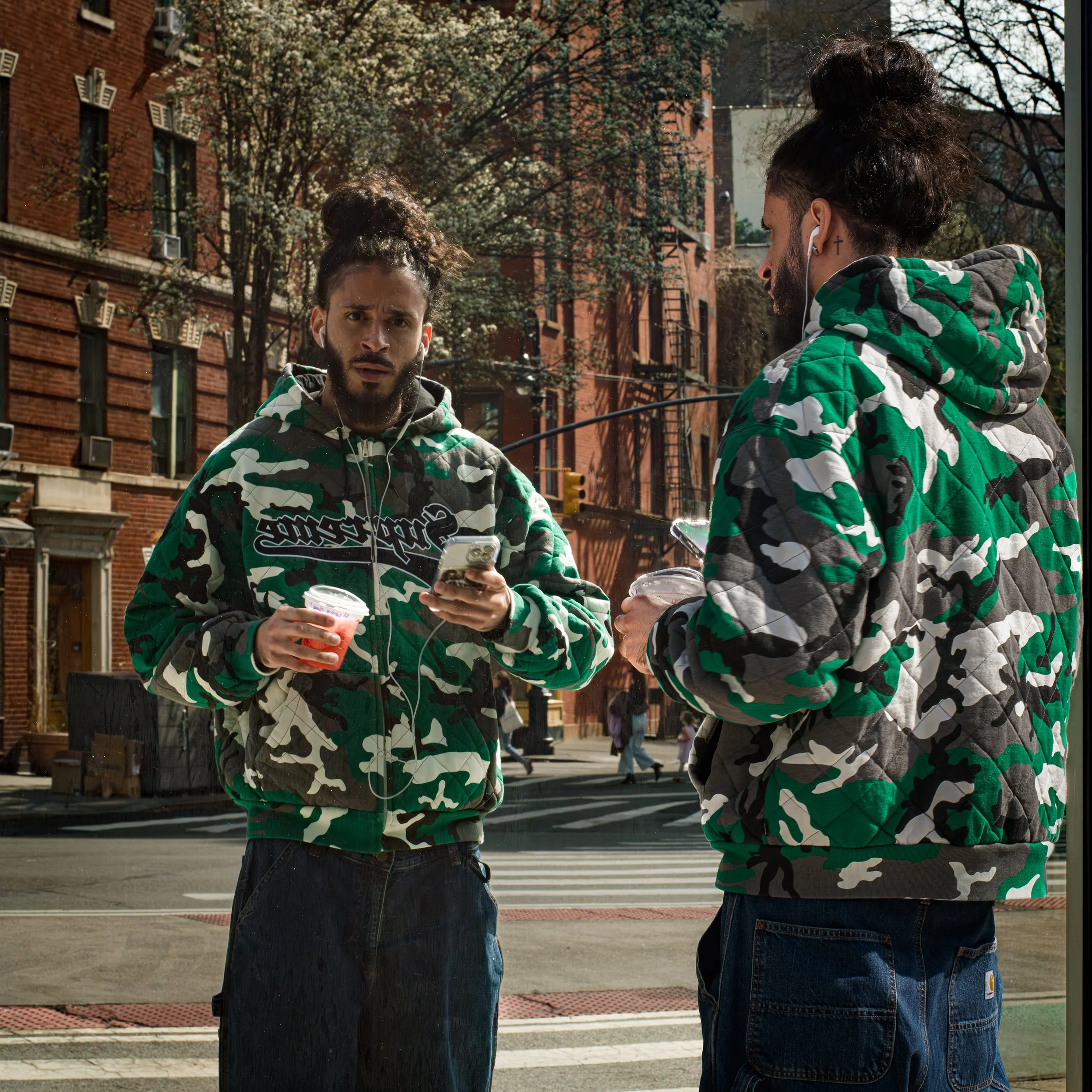 In New York Manhattan, A man is reflected in a mirror, creating a surprising image