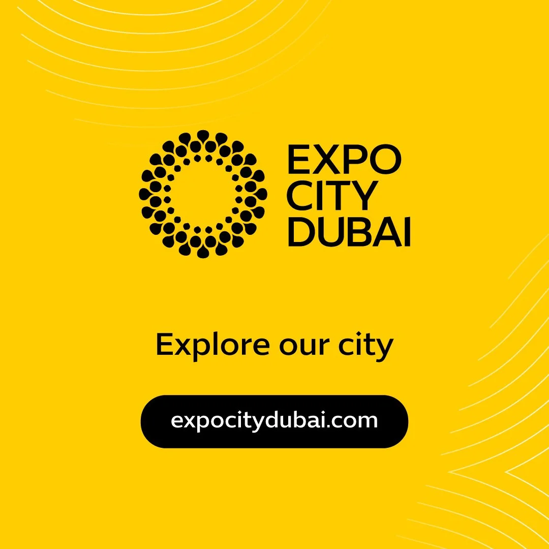 Yellow promotional graphic for Expo City Dubai with a circular logo made of black dots, black text stating "EXPO CITY DUBAI," and a call to action to explore the city via expocitydubai.com.