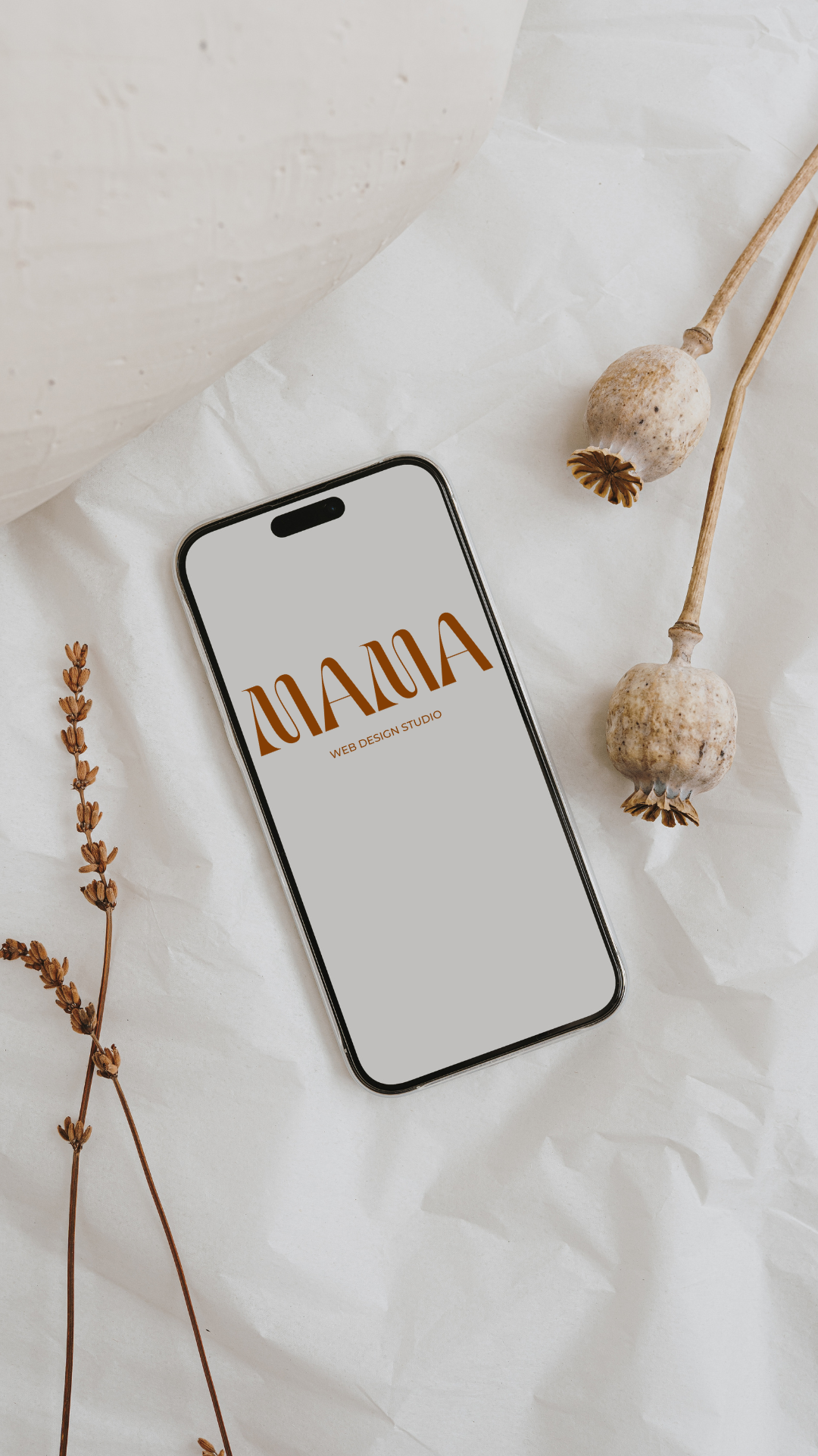 Mama Design Studio branding shown on a mobile phone, highlighting mobile-first web design.