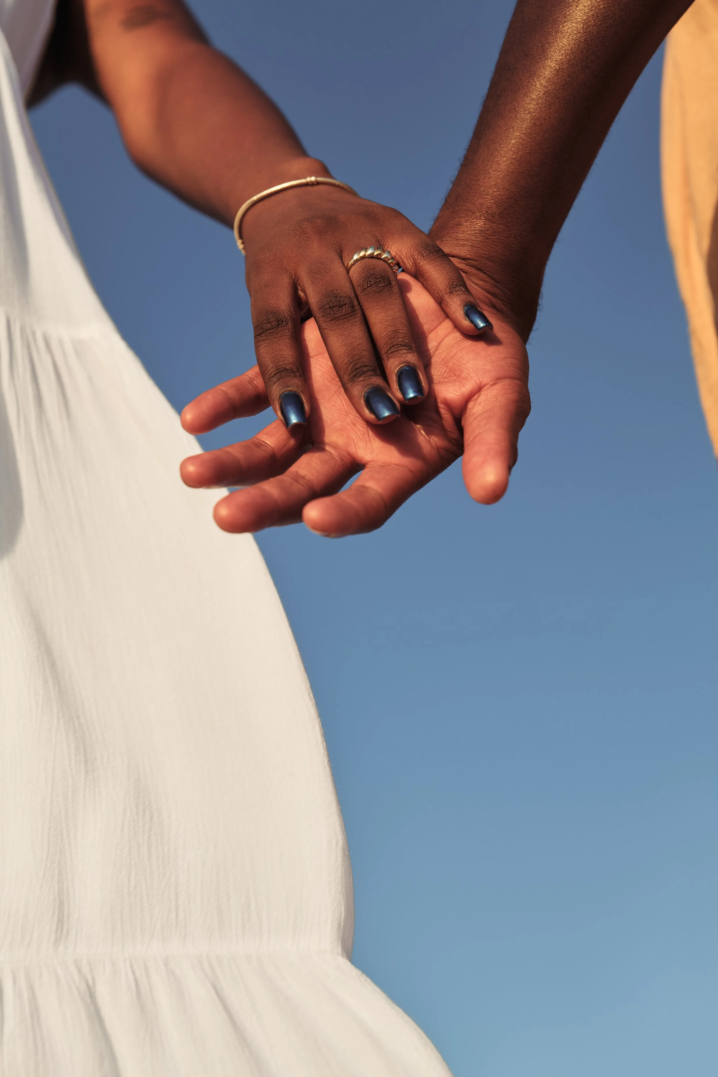 crop-african-couple-holding-hands-in-sunlight-2026-01-06-09-29-57-utc.jpg