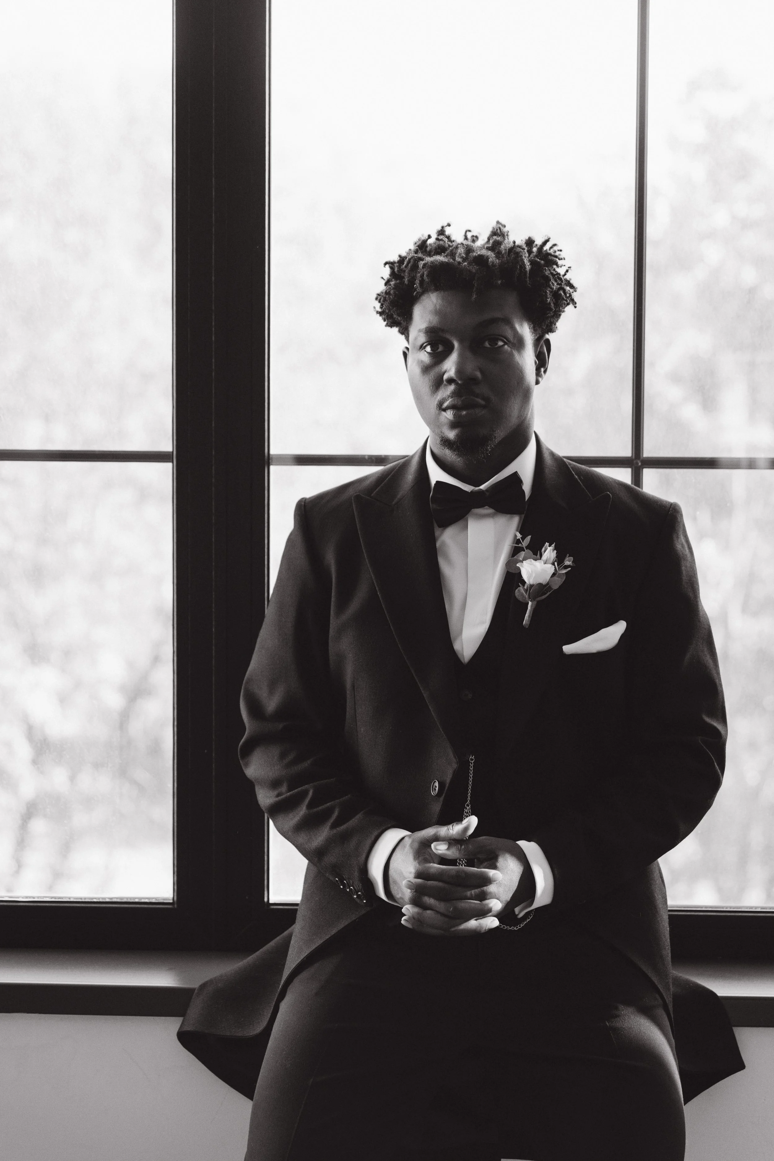 elegant-groom-wearing-suit-sitting-next-to-a-windo-2026-01-08-02-08-08-utc.jpg