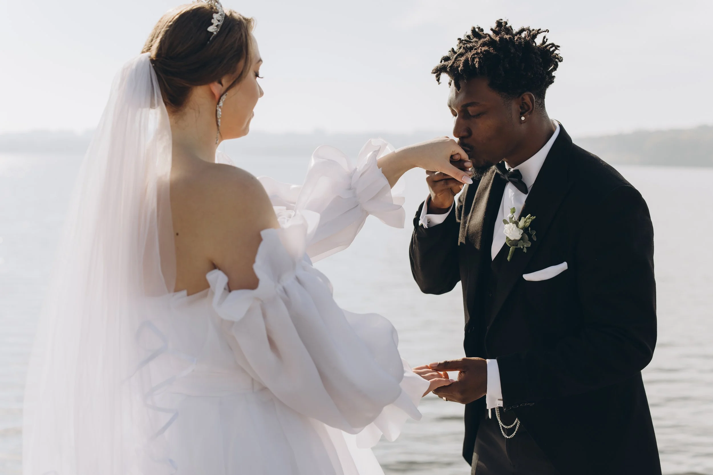 groom-kissing-bride-s-hand-during-interracial-wedd-2026-01-08-02-08-11-utc.jpg