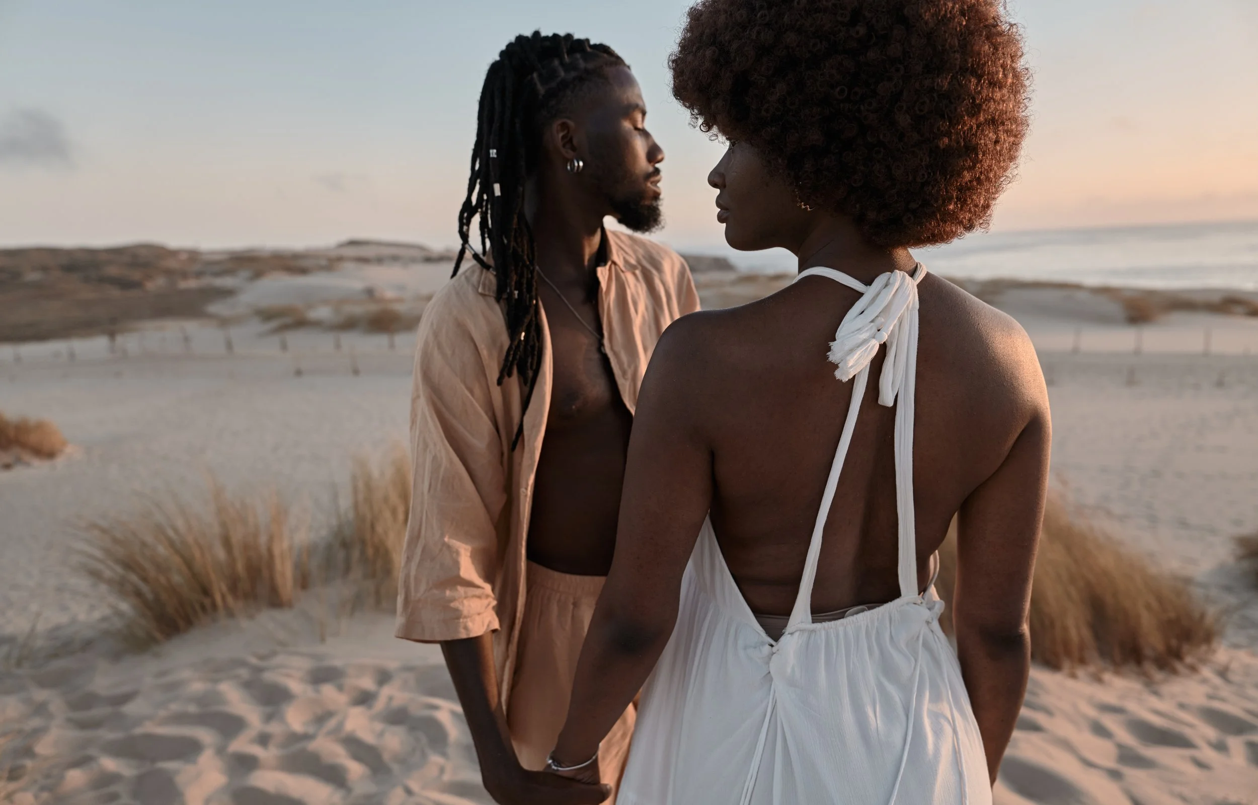 young-black-couple-standing-on-sandy-beach-near-se-2026-01-09-01-20-14-utc.jpg