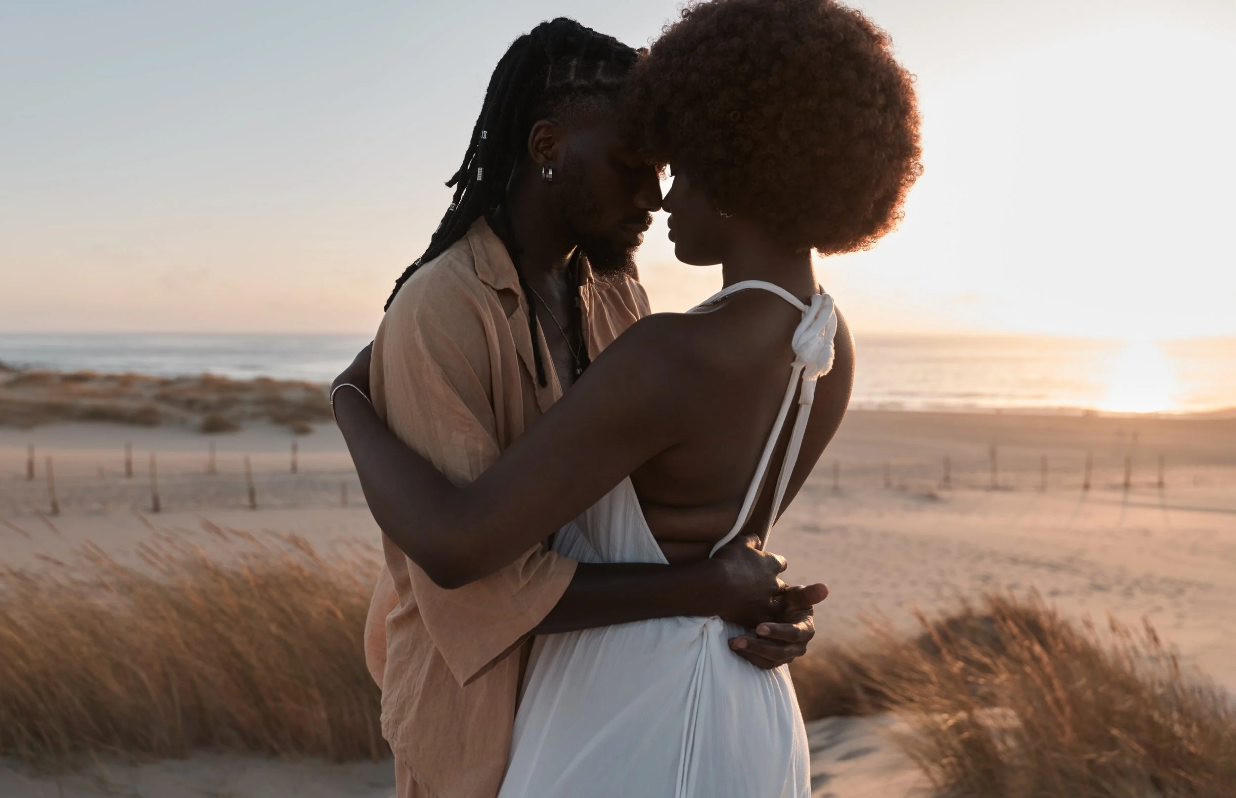 happy-black-couple-standing-and-embracing-on-sand-2026-01-08-22-15-29-utc.jpg