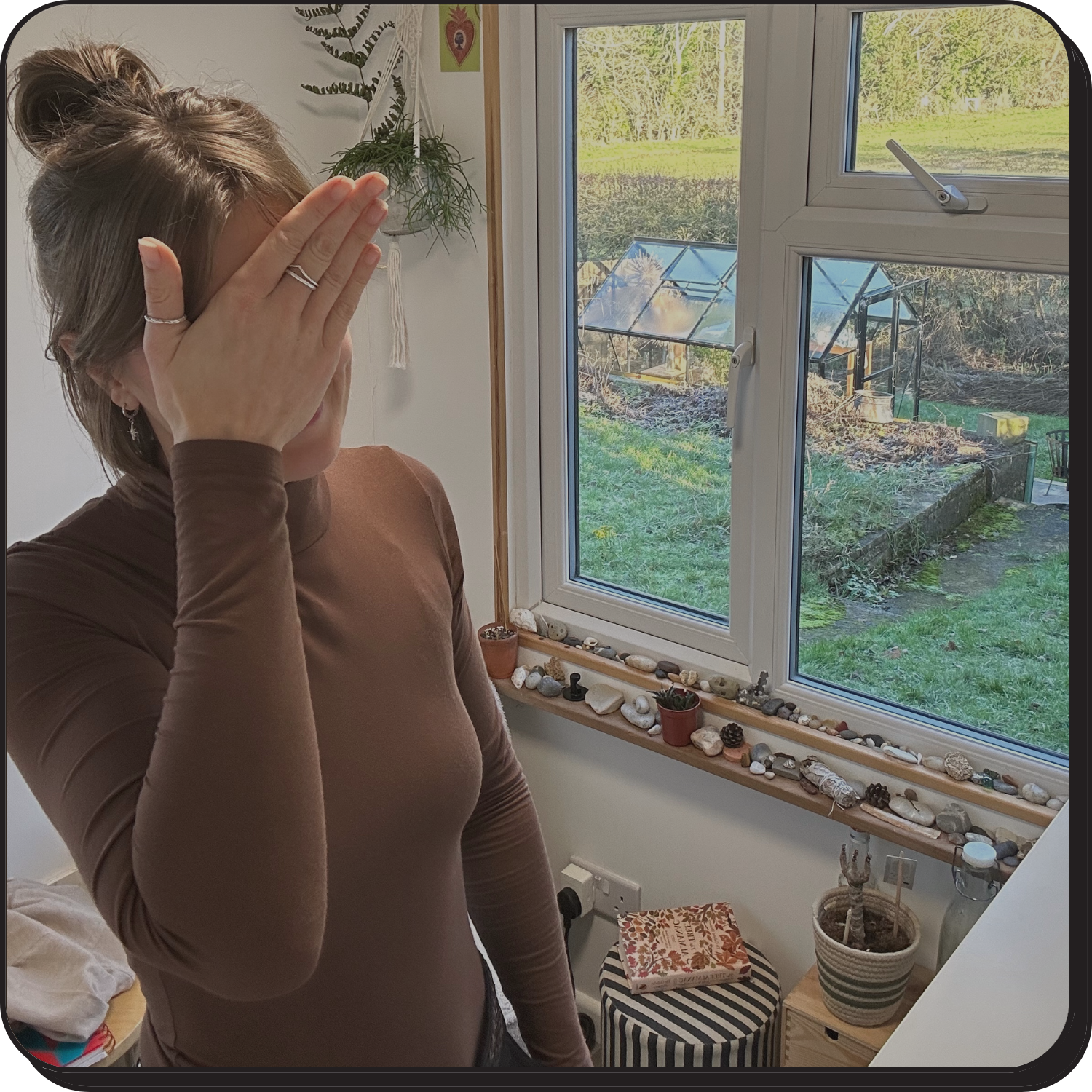 EJ standing in her office with her palm to her face like ooops!