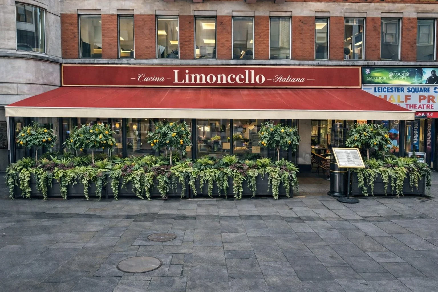 Italian restaurant called Limoncello with red awning and plants with lemons outside, situated on a city street.