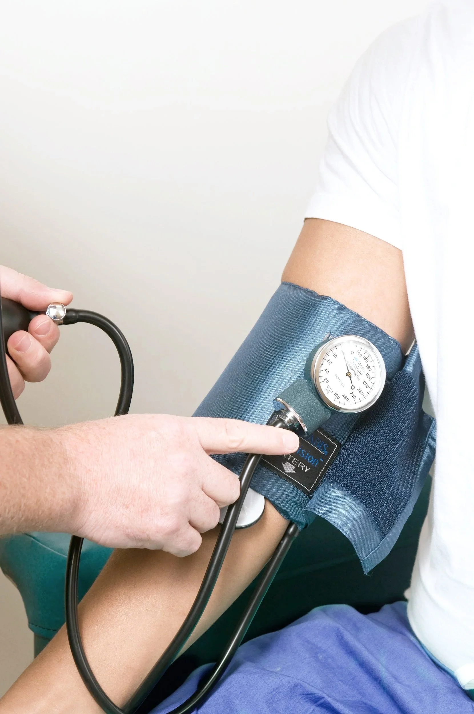 Blood pressure cuff fitted around a patient’s arm during a health check