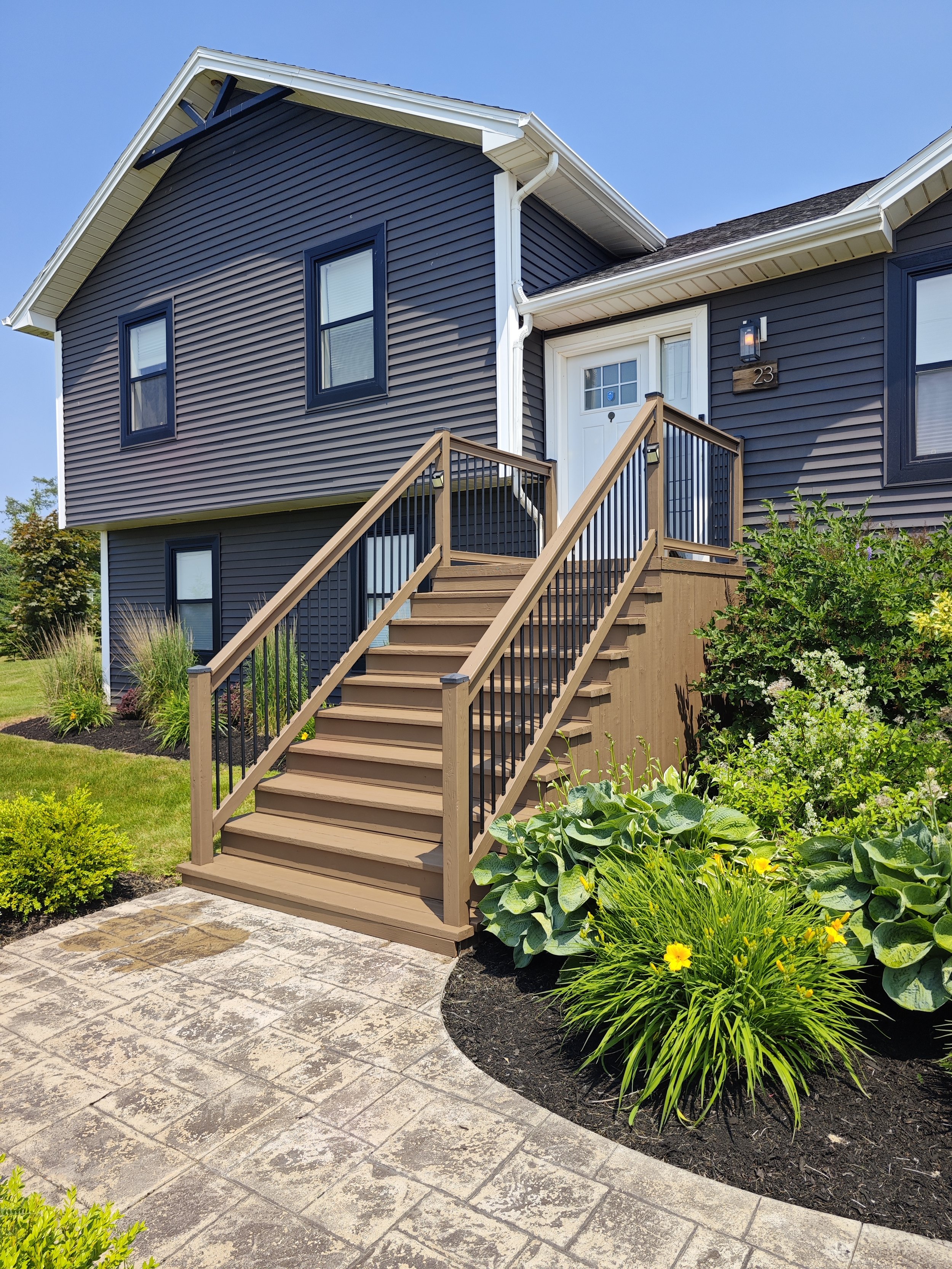 Exterior painting project completed in Stratford, PEI. The front entrance, stairs, railings, trim, and entry door were professionally prepared and painted to give the home a fresh, clean appearance while providing long-lasting protection from the ele