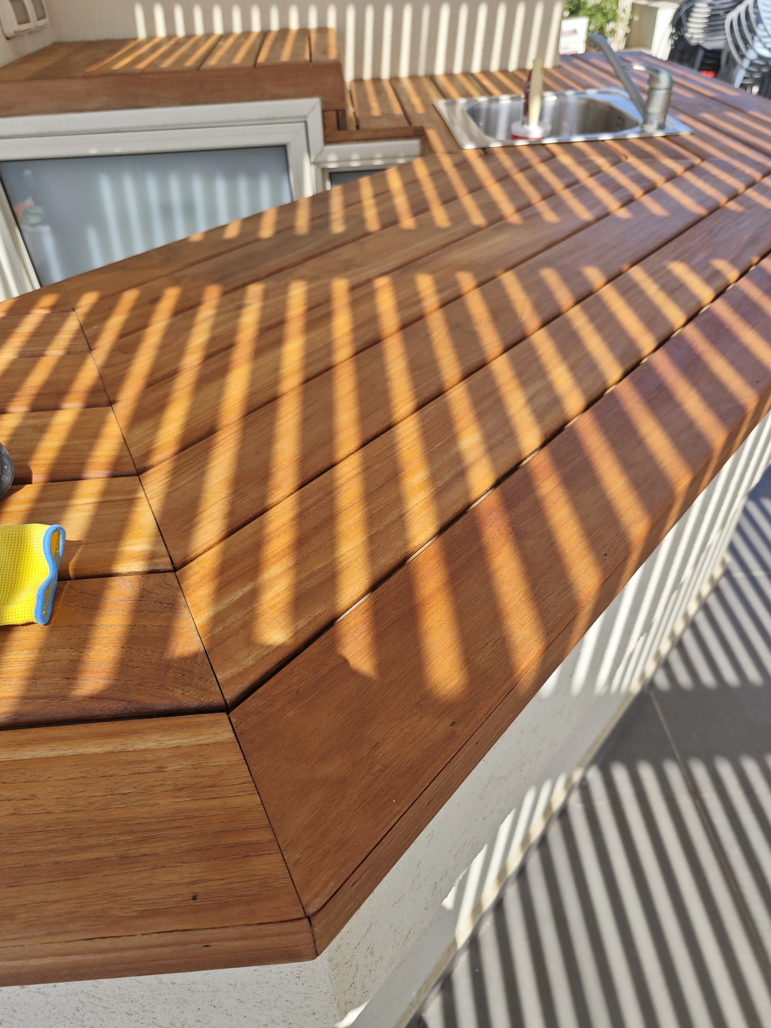 Outdoor kitchen counter installation with wood finish for a residential project in Fall River