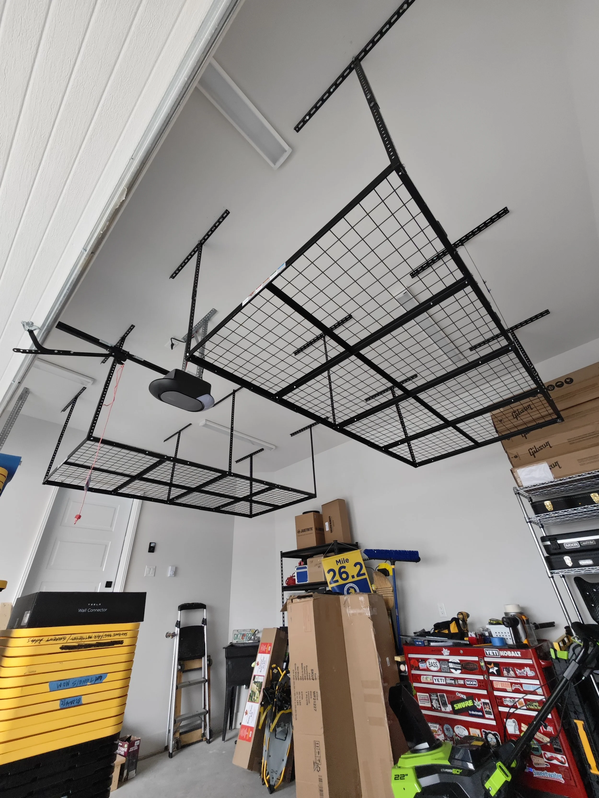 Garage storage rack installation for overhead organization in Timberlea. Secure mounting to ceiling joists for safe and efficient storage.