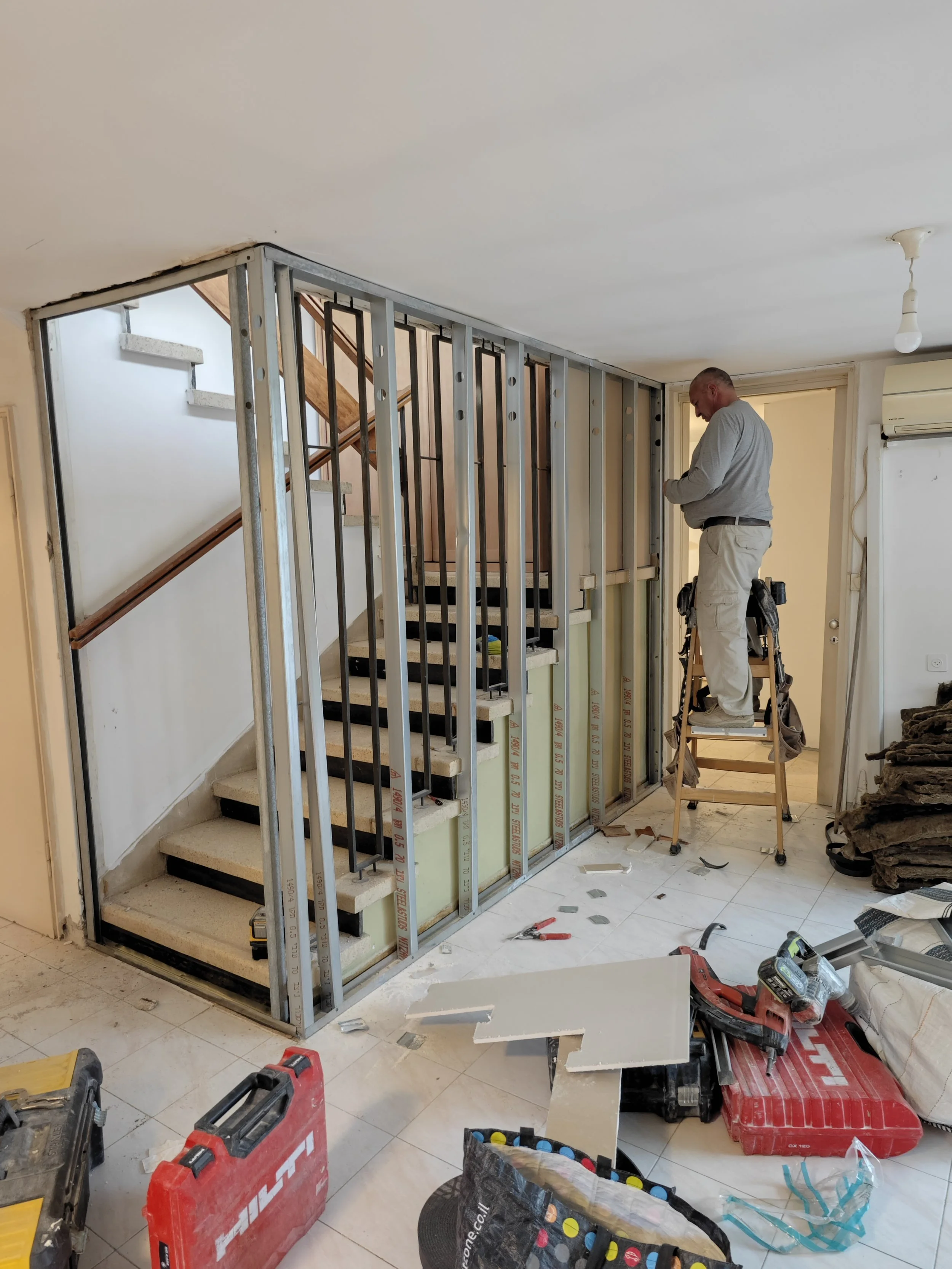 Wall framing and drywall installation between basement and main floor for a residential project in Dartmouth & Area