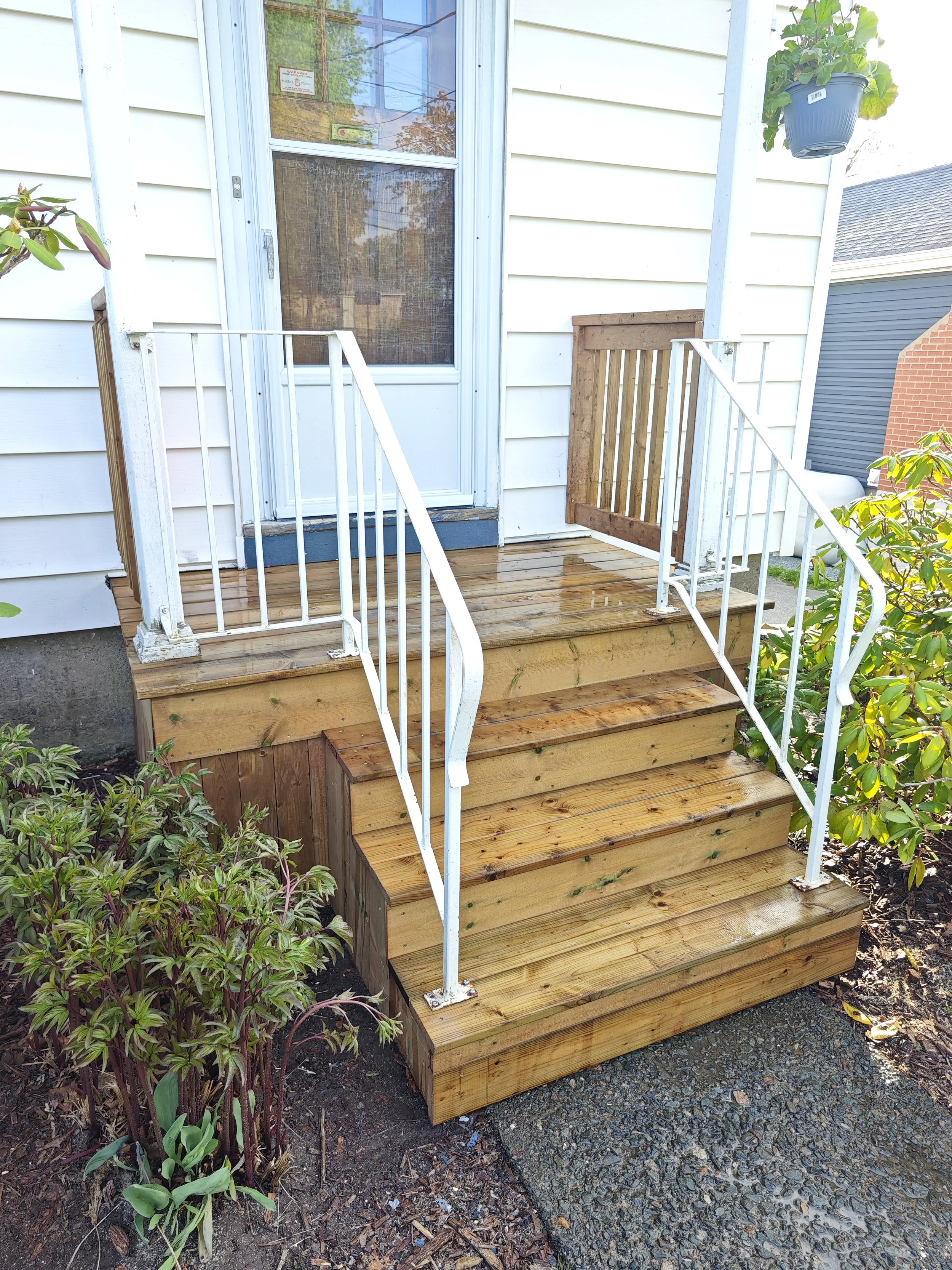 Finished pressure-treated deck stairs with sturdy safety railings in Stratford, PEI.