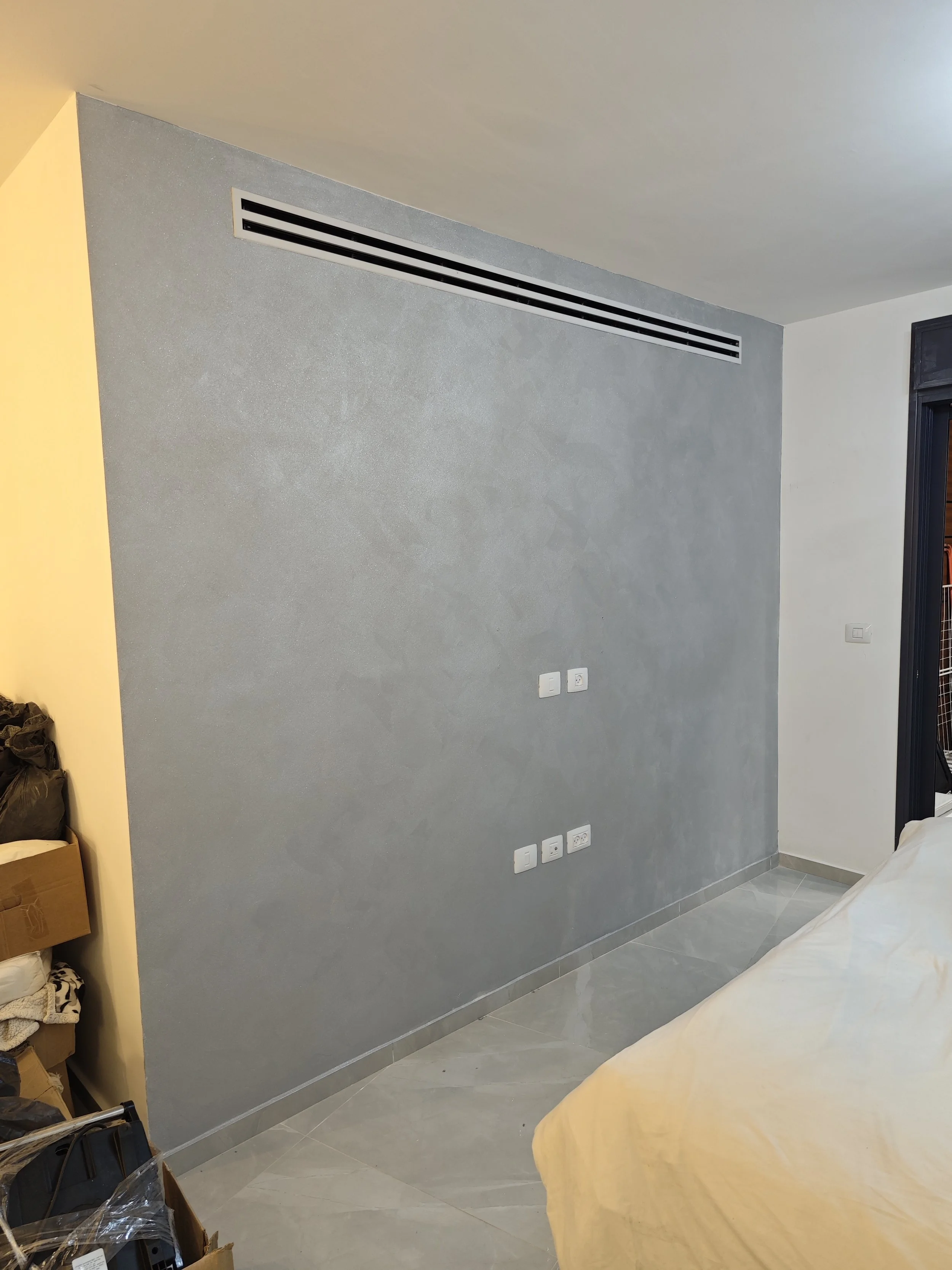 Decorative feature wall with stucco-style finish completed for a residential interior in Halifax