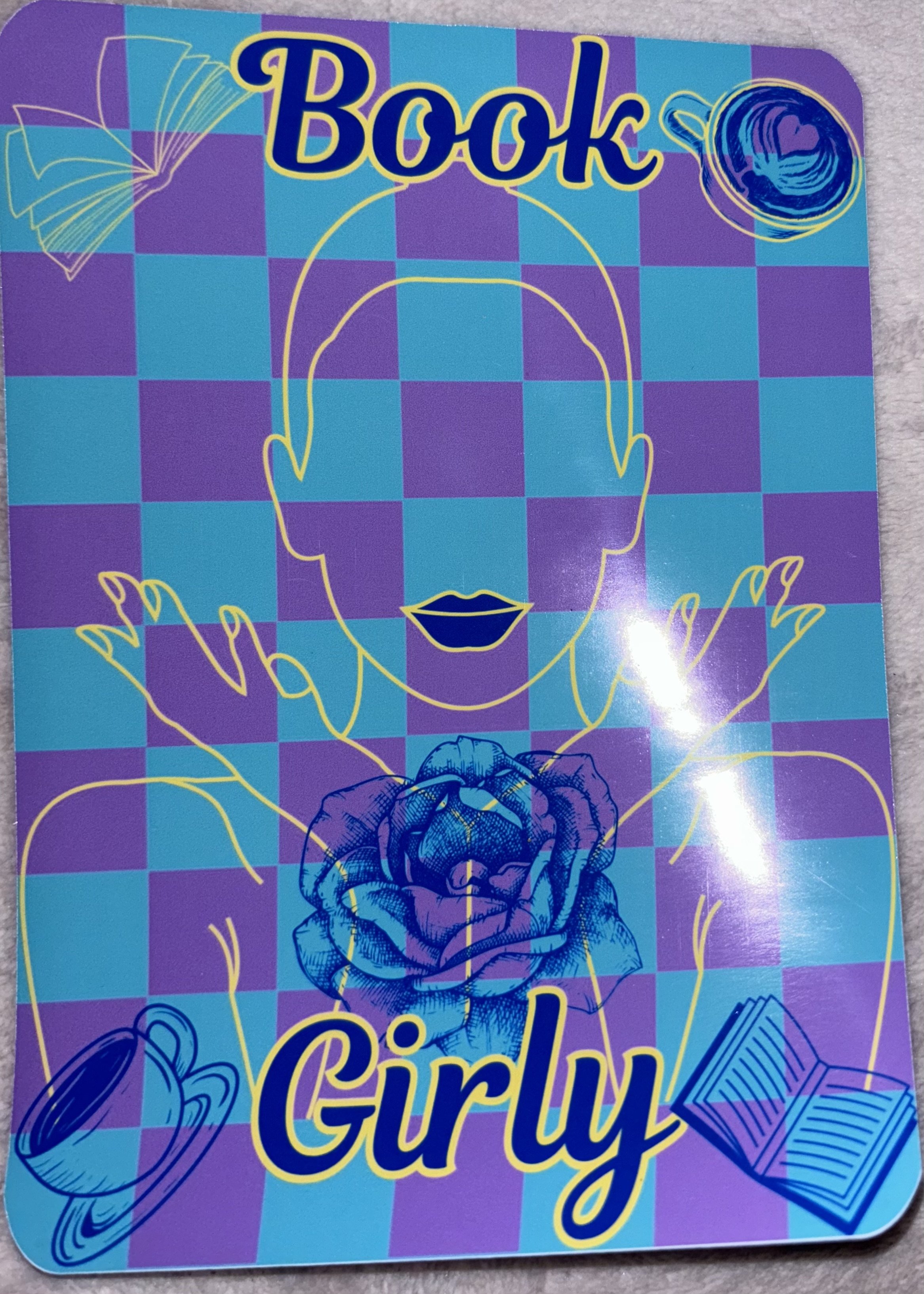 Colorful book cover with abstract line art of a woman's face, a rose, a coffee cup, and a book, with the words "Book Girly" in bold navy and yellow font.