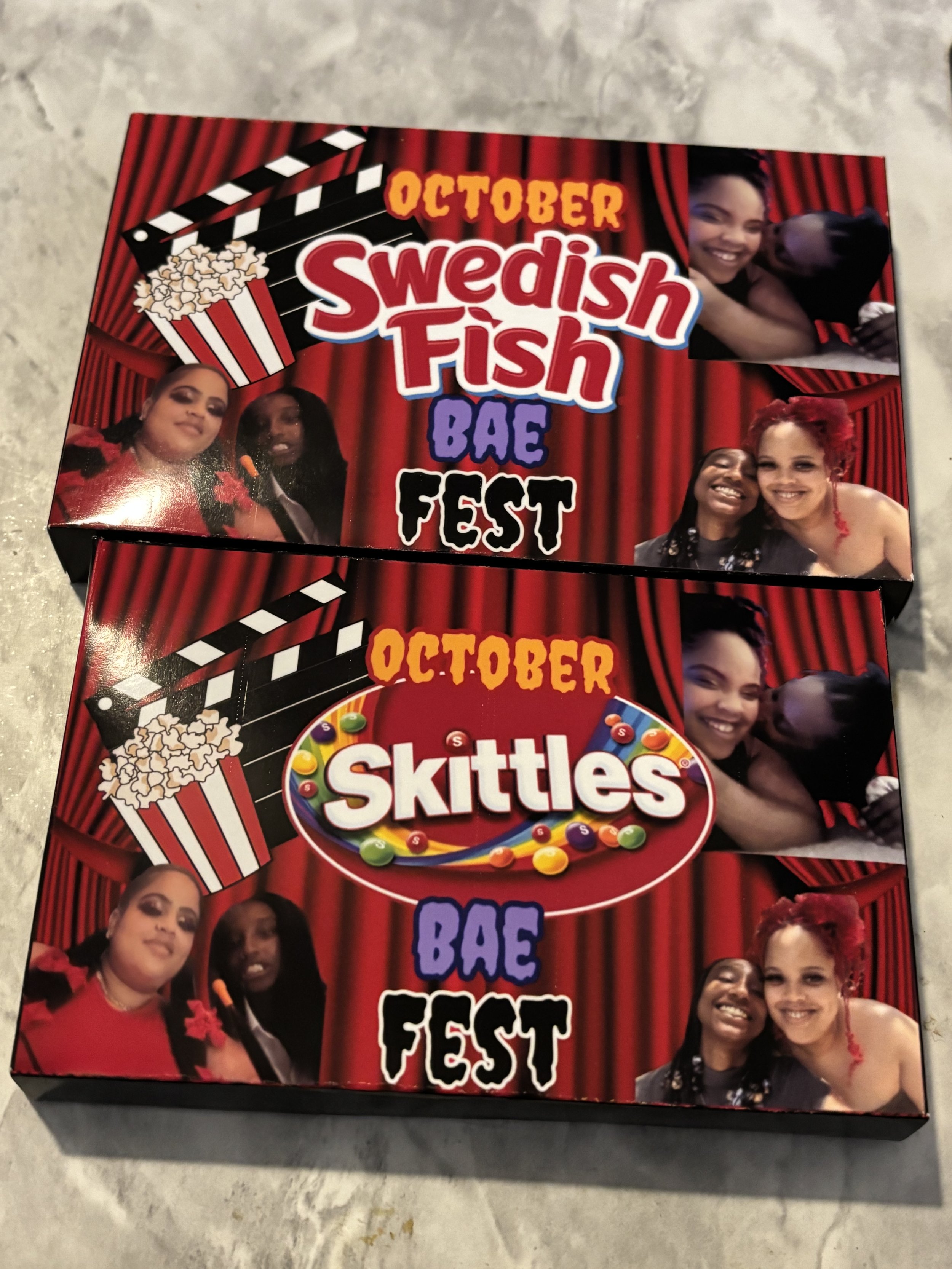 Two boxes of candy and movie-themed decorations for a Bae Fest event, featuring images of women smiling and hugging, with red theater curtains and popcorn graphics.