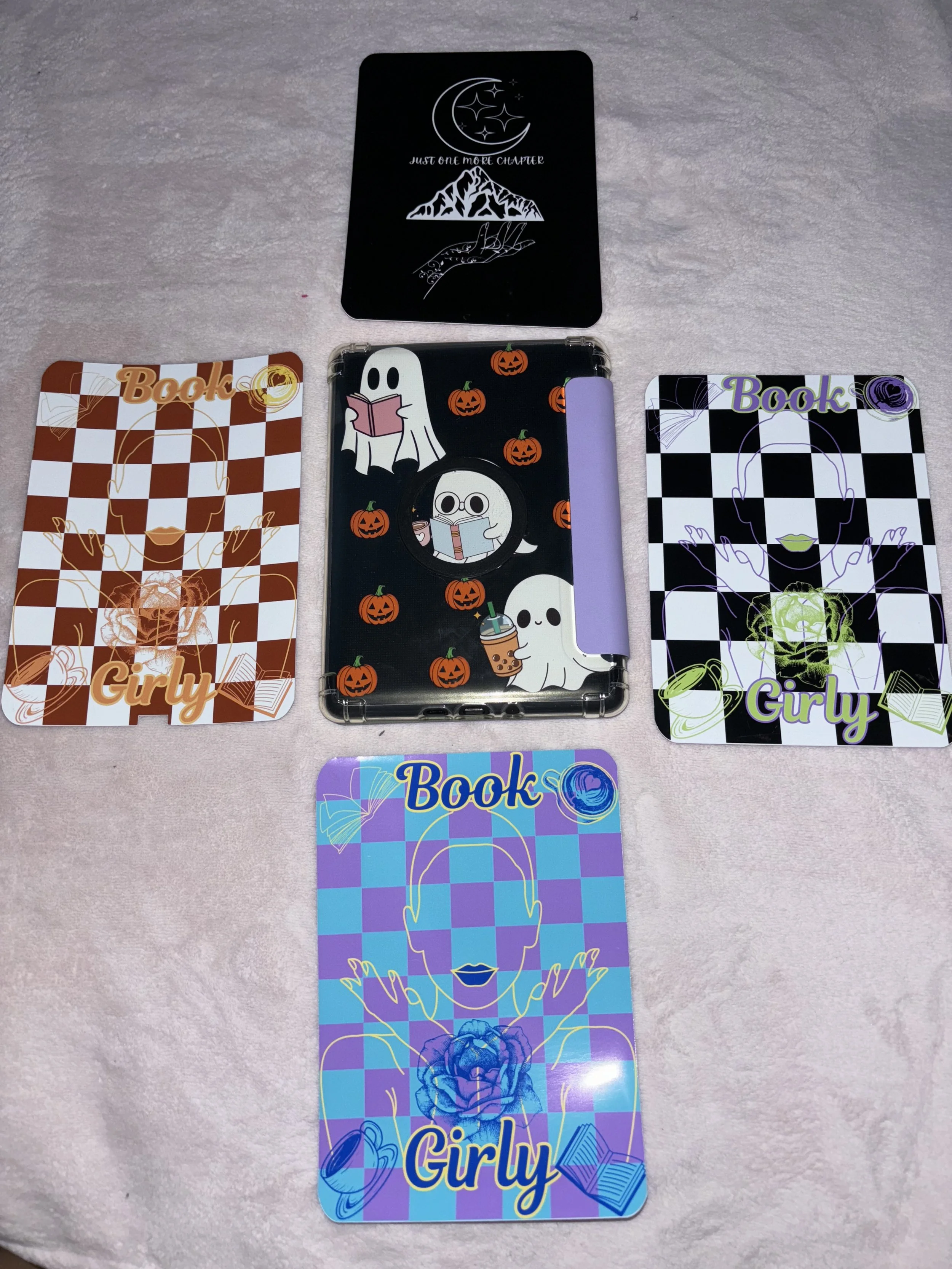 Four colorful cards with the words 'Book Girly' and features of women with different designs, and a black card with moon, stars, mountain, and hand images at the top.