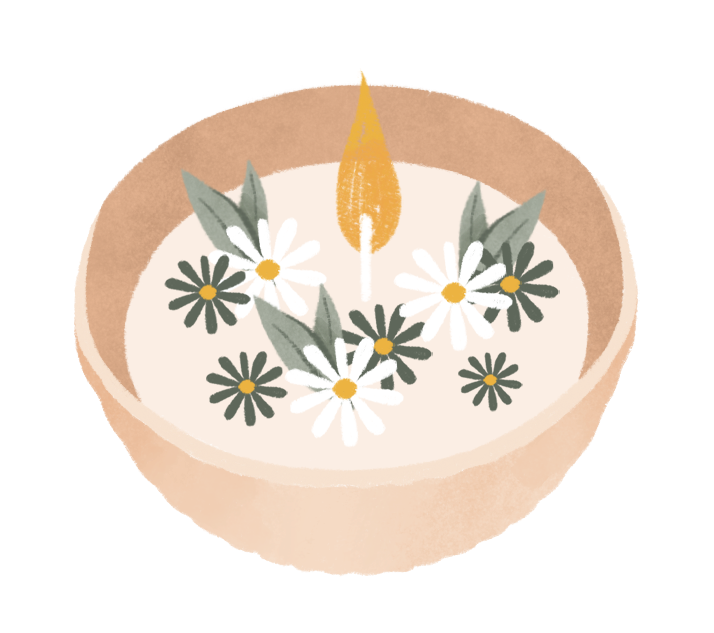 Bougie avec une flamme, entourée de fleurs blanches et noires dans un récipient