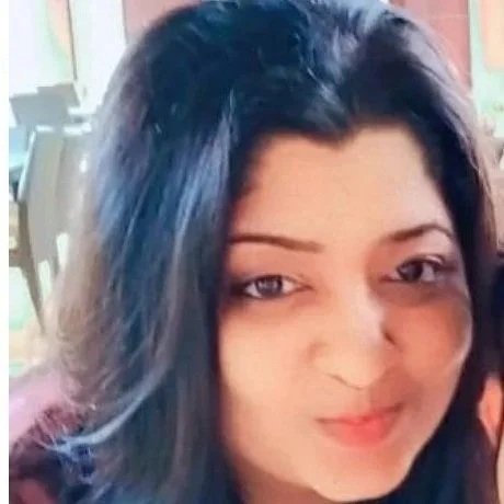 Close-up of a woman with dark hair smiling.