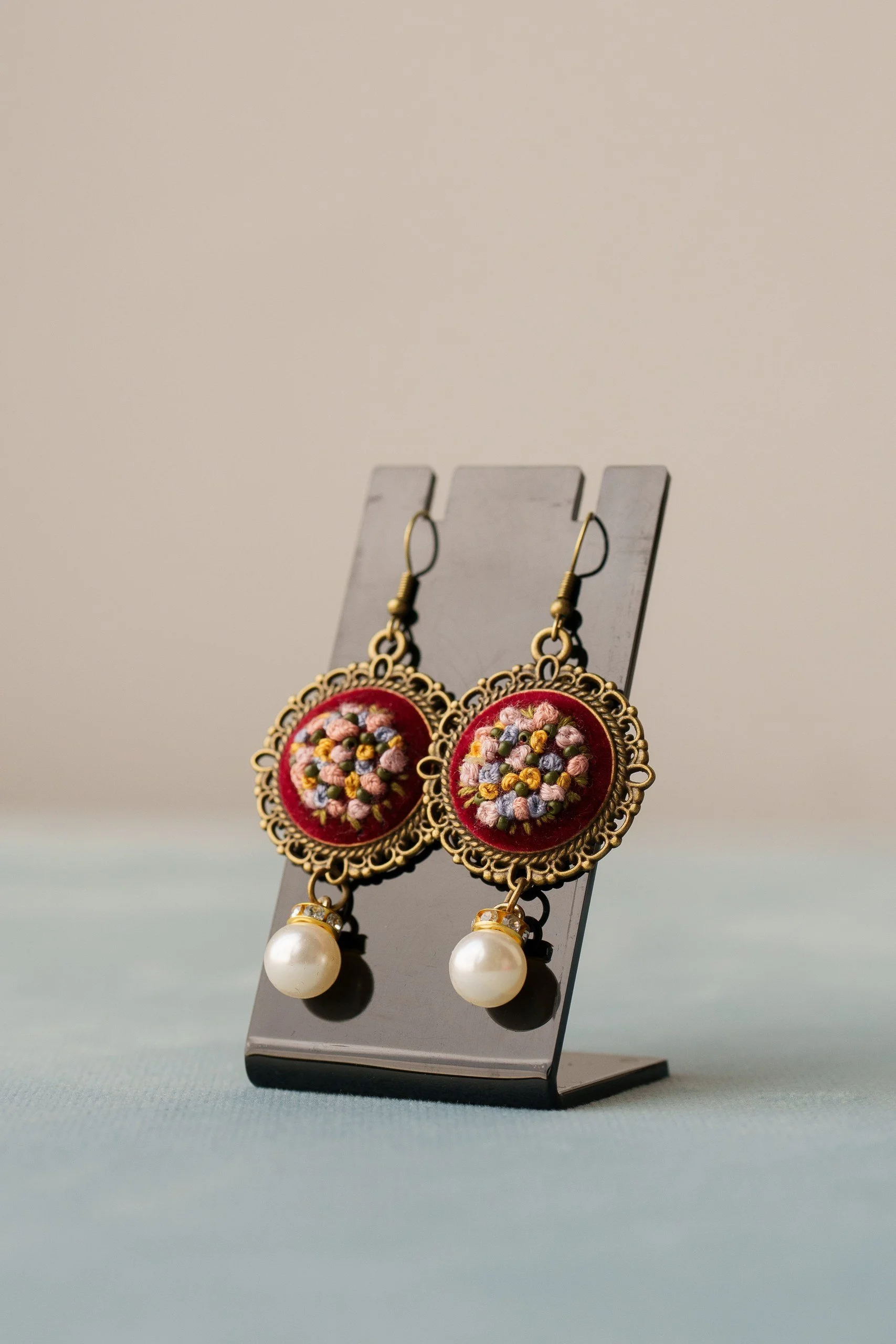 Embroidered earrings with bouquet and pearl.jpg