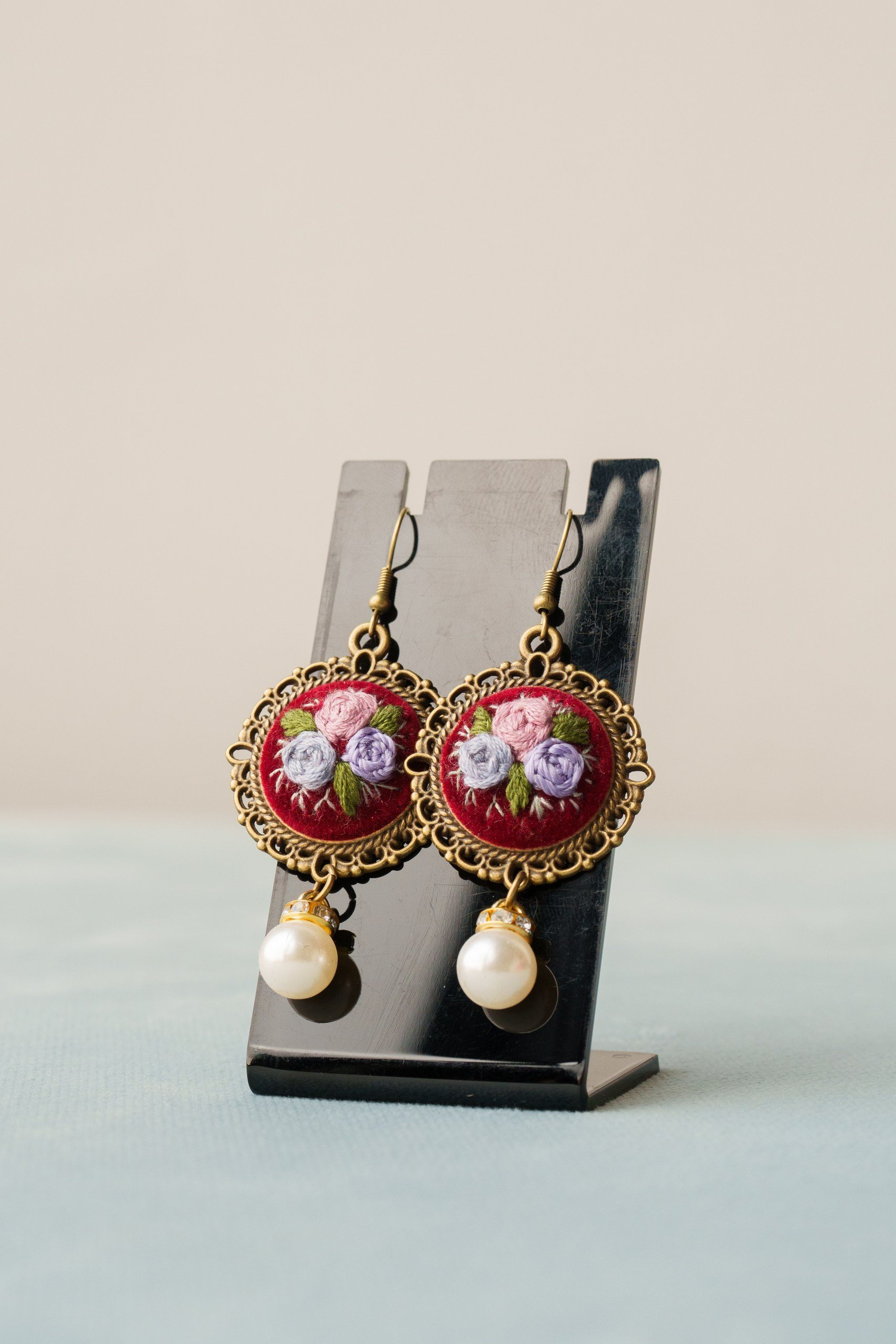 Embroidered earrings with pastel bouquet and pearl.jpg
