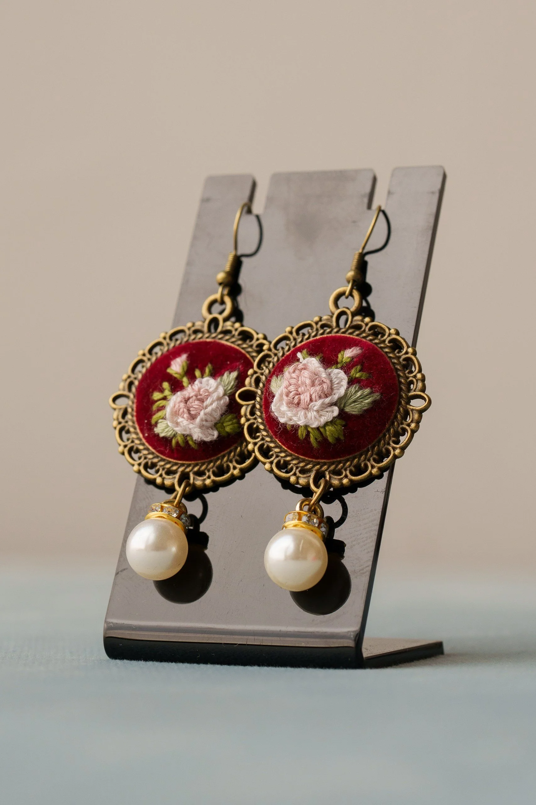 Embroidered earrings with pink rose and pearl.jpg