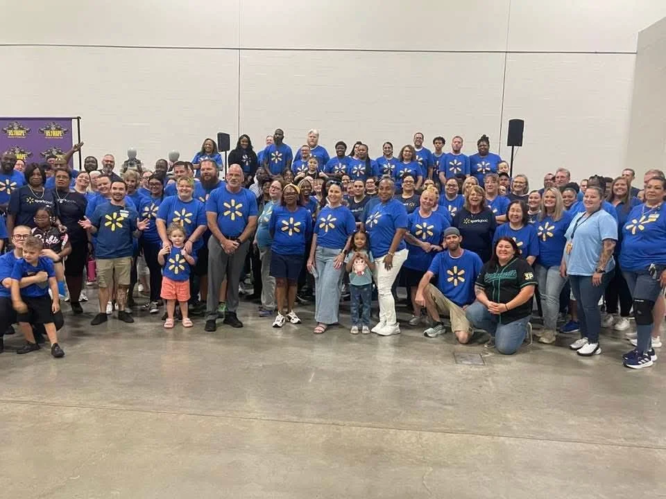 Gerrie Ford-Hardin with hundreds of children she gives backpacks to every year in a "pack the sack" event.