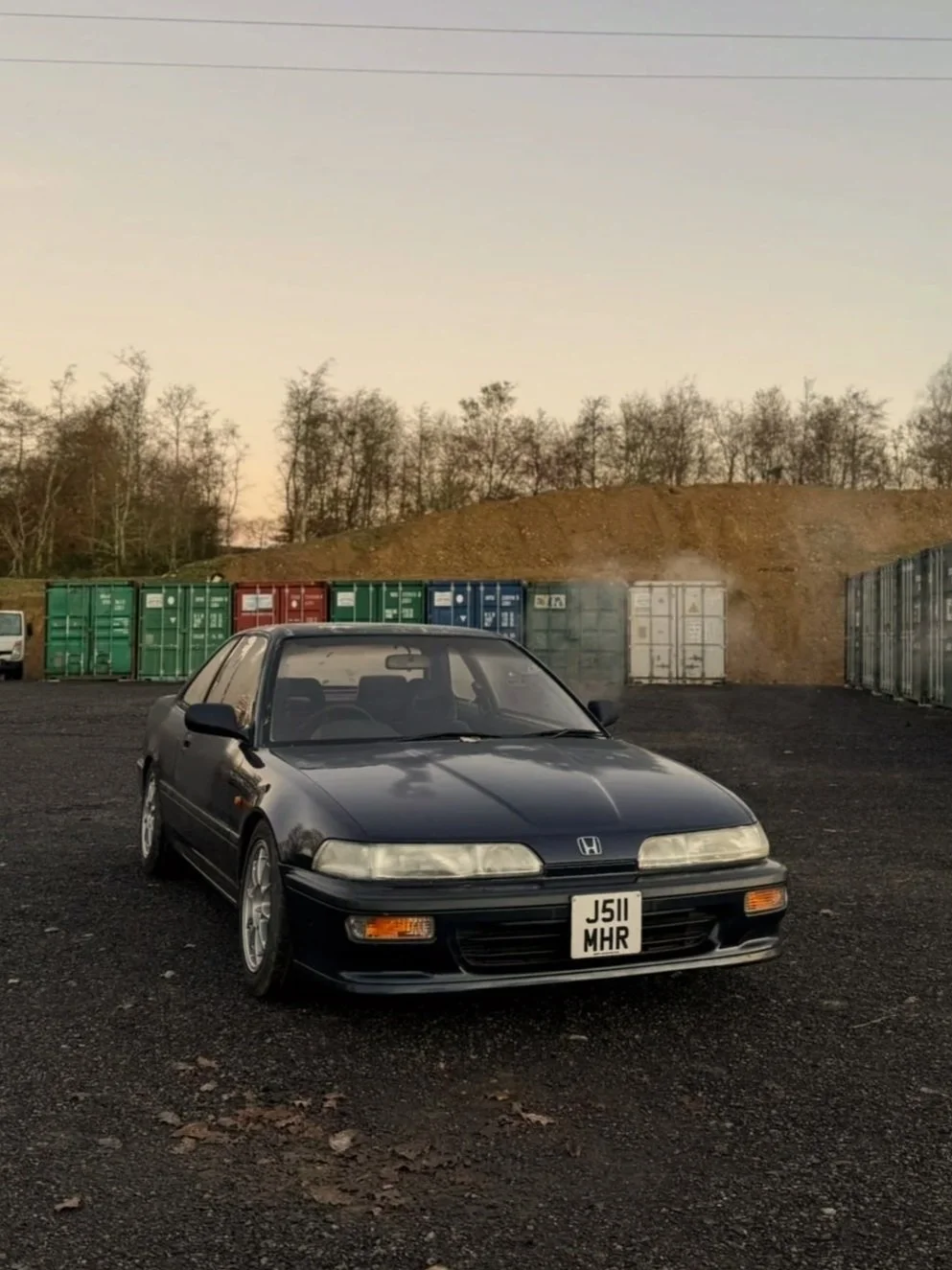 A picture of a Honda Integra DA Chassis in a lovely sunrise setting