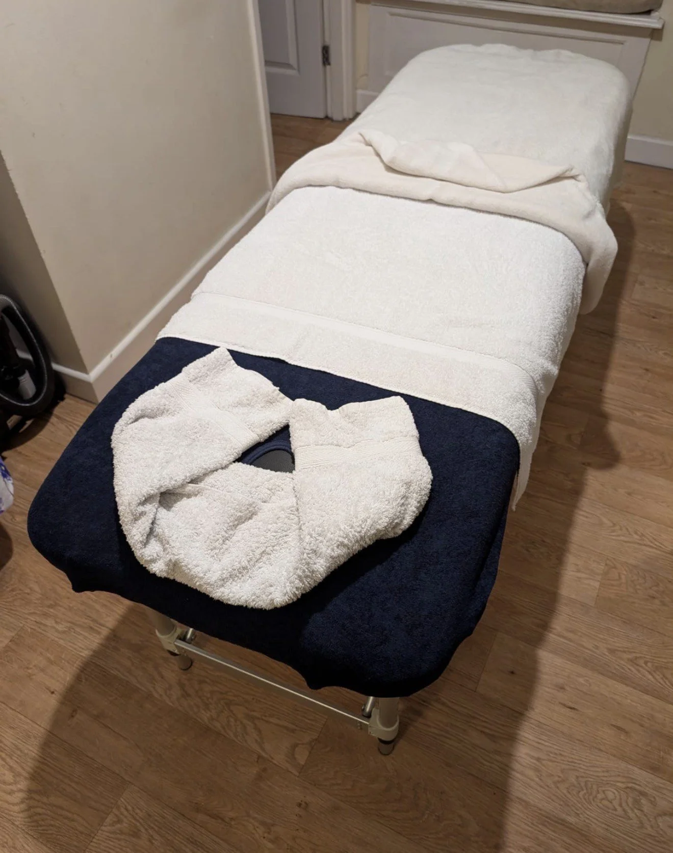 Professional mobile massage therapy setup including a high-quality massage table, fresh linens, and oils for home treatments in Trowbridge and Chippenham